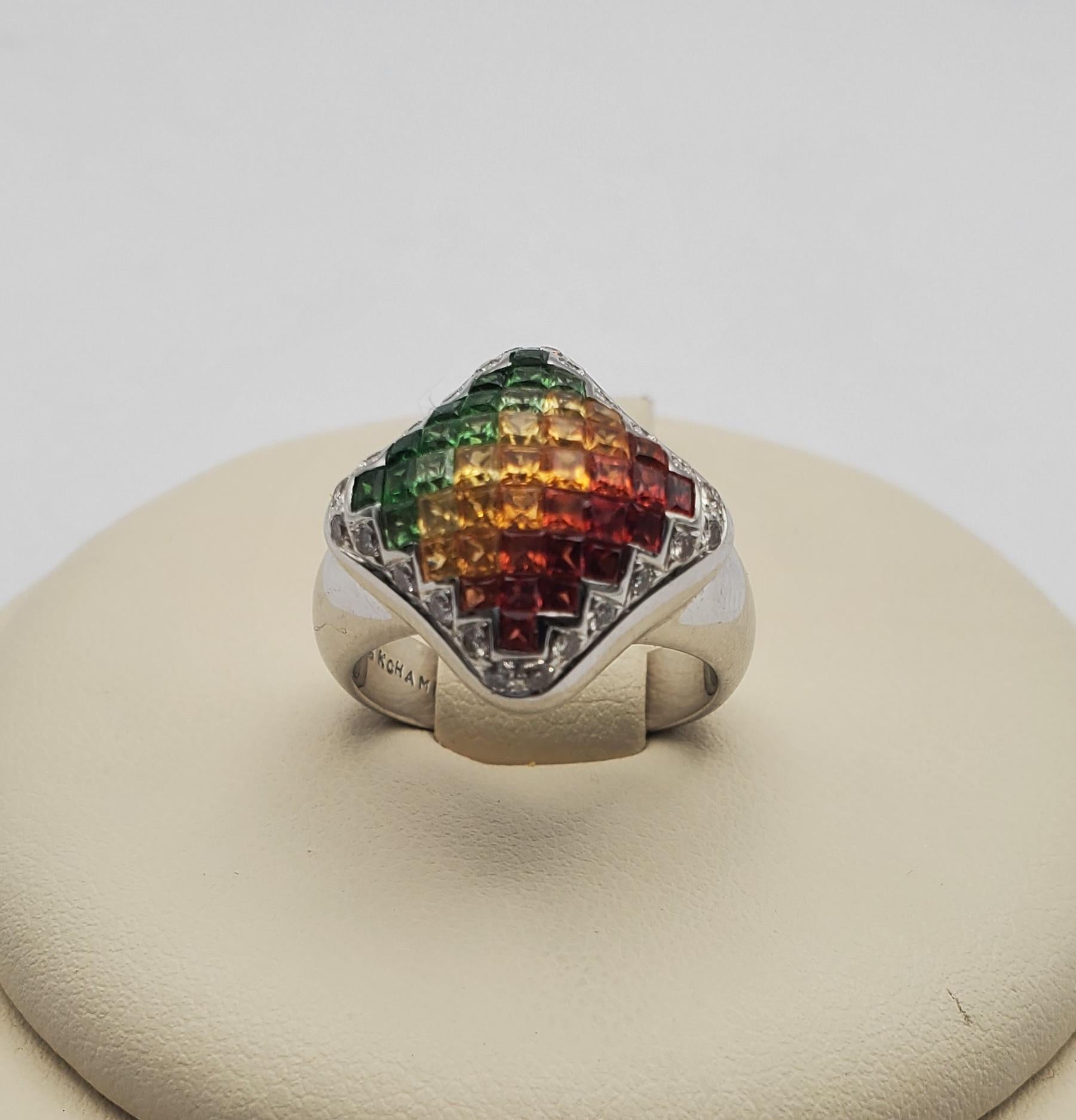 Gorgeous Chameleon brand gradient/ombre ruby, citrine and tsavorite garnet ring. This ring features invisible set princess cut gem stones in a domed square shape surrounded by a halo of bead set round diamonds. This modern and colorful piece is