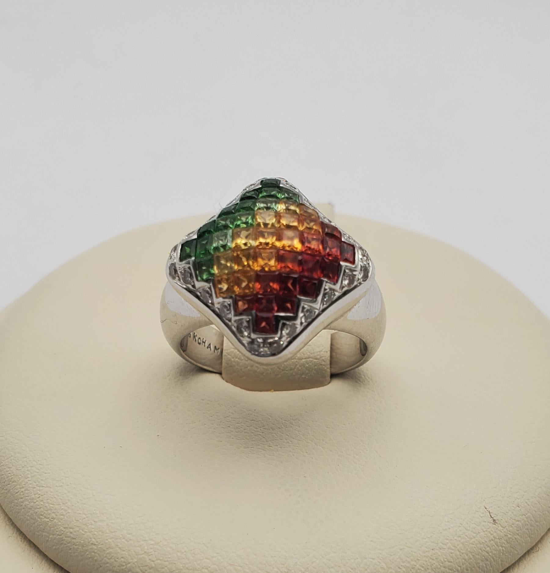 Gorgeous Chameleon brand gradient/ombre ruby, citrine and tsavorite garnet ring. This ring features invisible set princess cut gem stones in a domed square shape surrounded by a halo of bead set round diamonds. This modern and colorful piece is