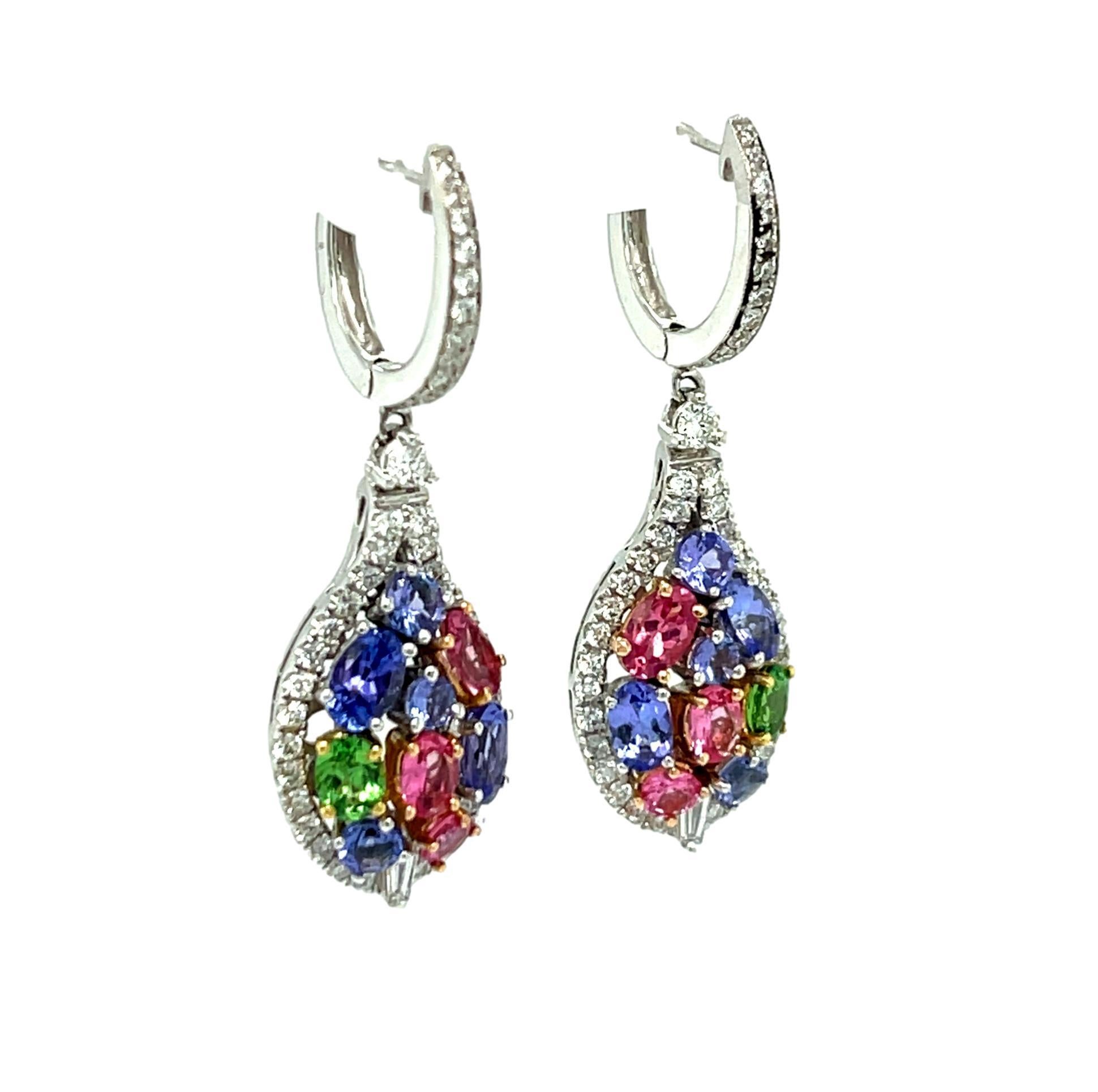 These stunning Drop and Dangle Diamond earrings have three fancy colored gemstones: Tsavorite, Tanzanite and Spinel all set in  18K white gold. There are 84 brilliant cut diamonds and 2 Baguette diamonds in this one of a kind earring. These vibrant