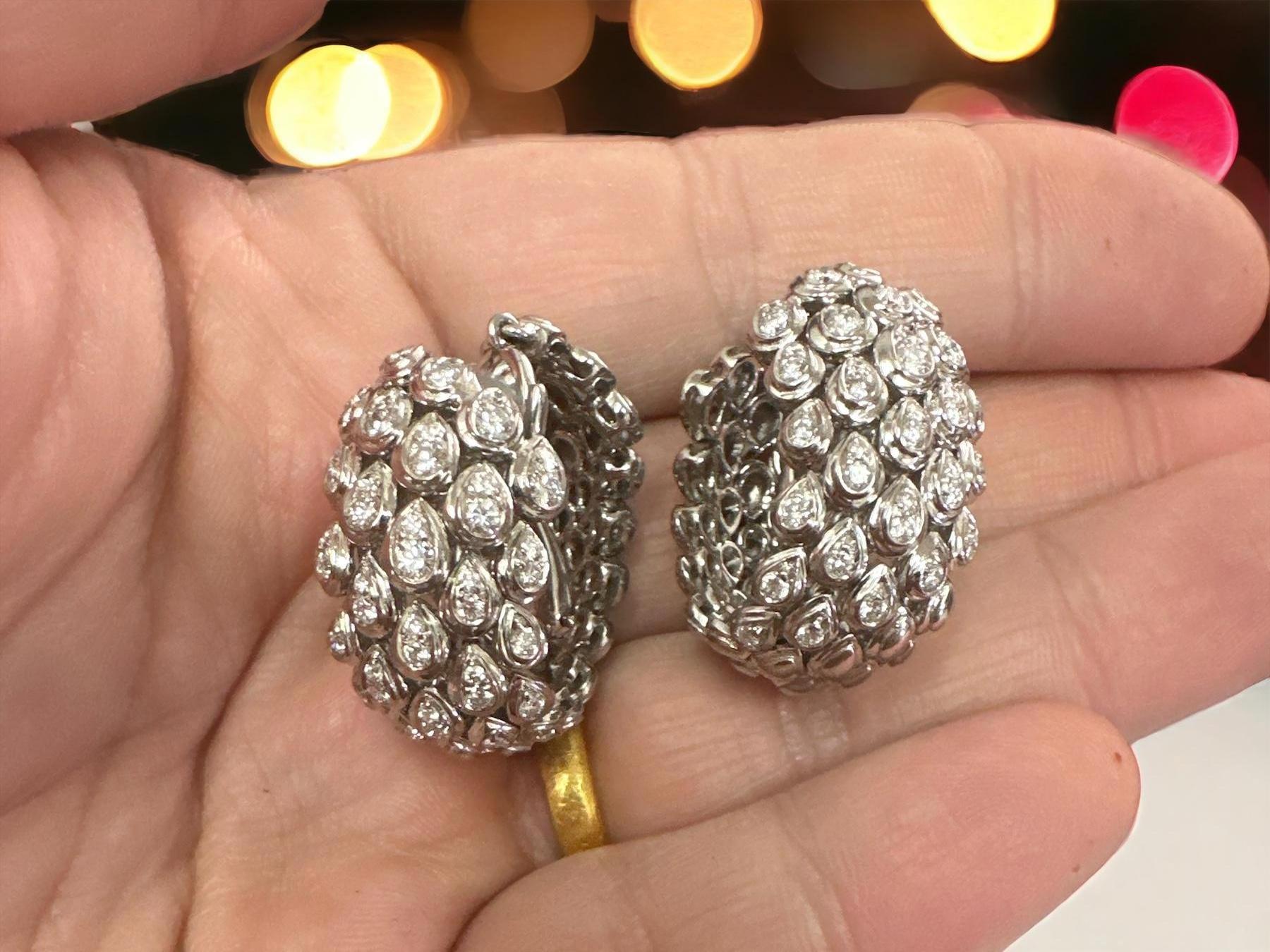 A stunning pair of 18kt white gold Faraone Italy diamond hoop earrings. These earrings represent a beautiful blend of Italian craftsmanship and luxury, and they are sure to be a captivating addition to any jewelry collection.

Faraone is a renowned