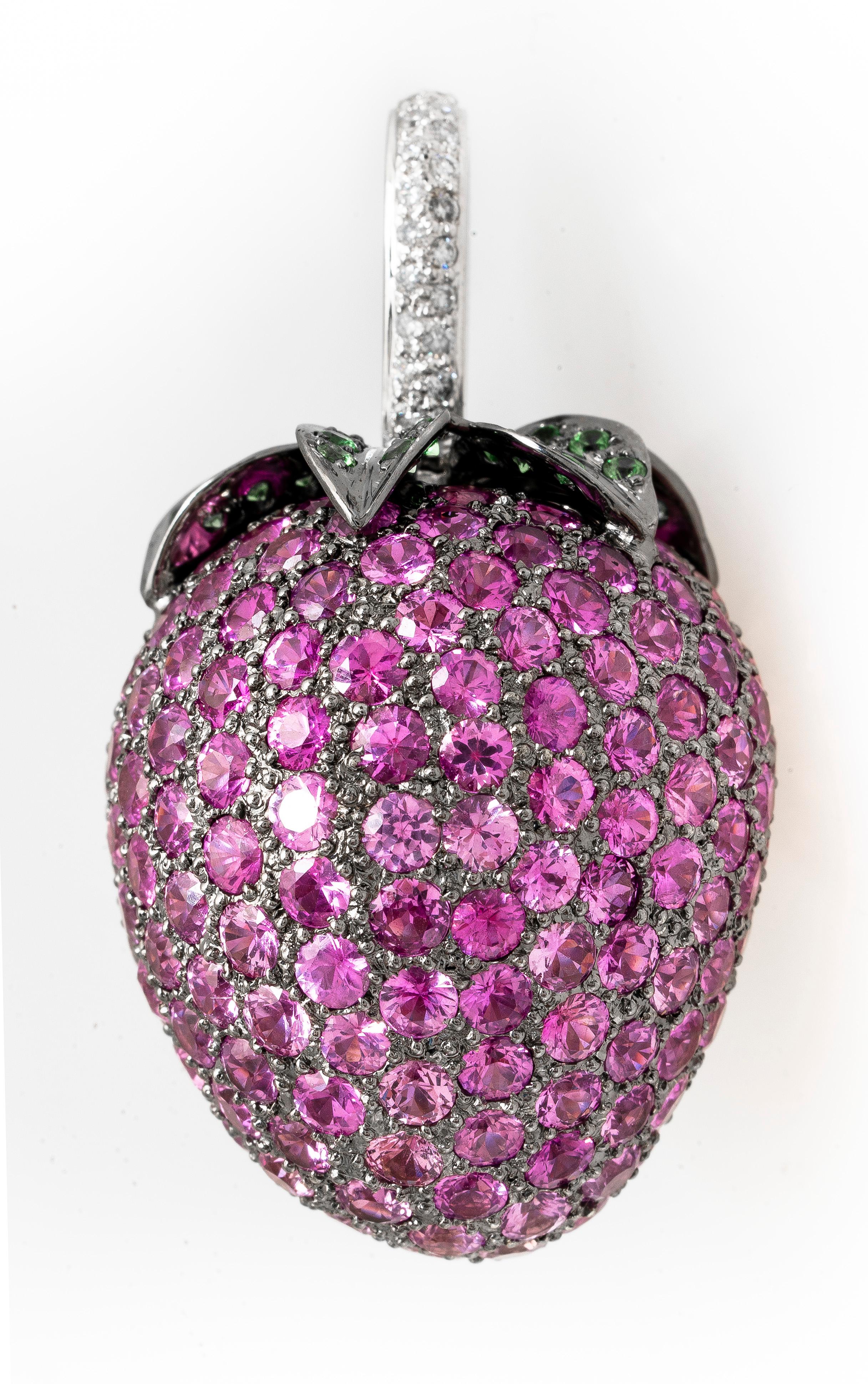 Vintage 18k white gold  large strawberry pendant with pave pink sapphires, tsavorite garnets and diamonds.  There are 12.66 carat total weight of rbc pink sapphires making up the flesh of the strawberry.  The leaves have 0.72 carat total weight of