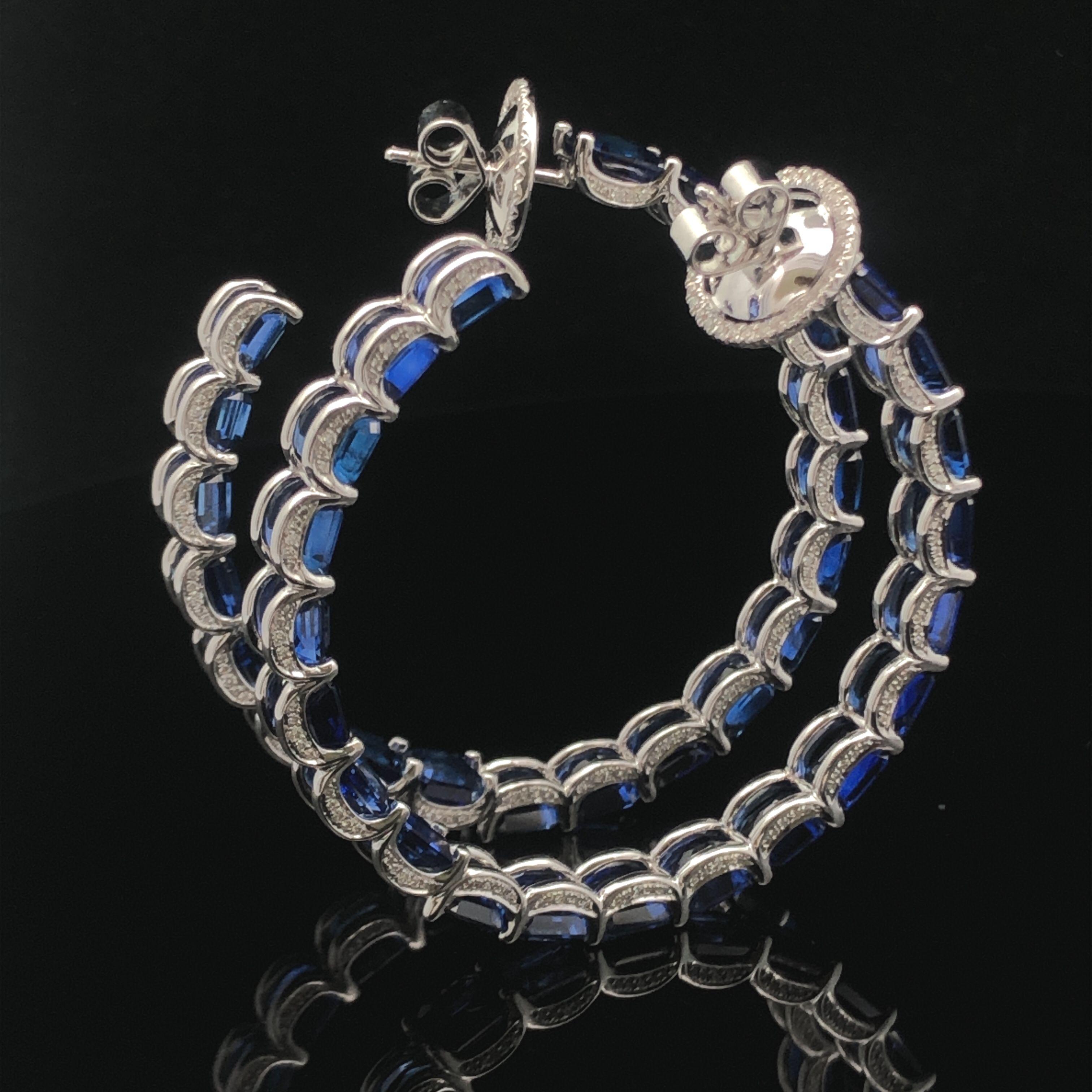 The 18K white gold large hoop earring with a stunning 32.05 CTS Sri Lanka sapphire and 0.77 CTS diamonds is not just a fashion statement; it exudes elegance and sophistication. The luxurious white gold, vibrant sapphire, and dazzling diamonds create