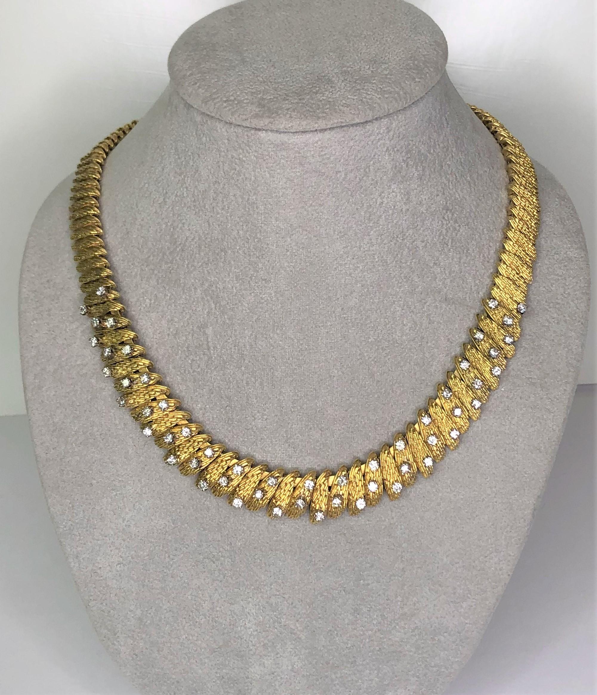 This is a one-of-a-kind item that would be a wonderful addition to anyone's jewelry collection!  
18 karat yellow gold textured design collar necklace.
53 round diamonds in a random pattern at the front of the collar.
Each diamond is approximately