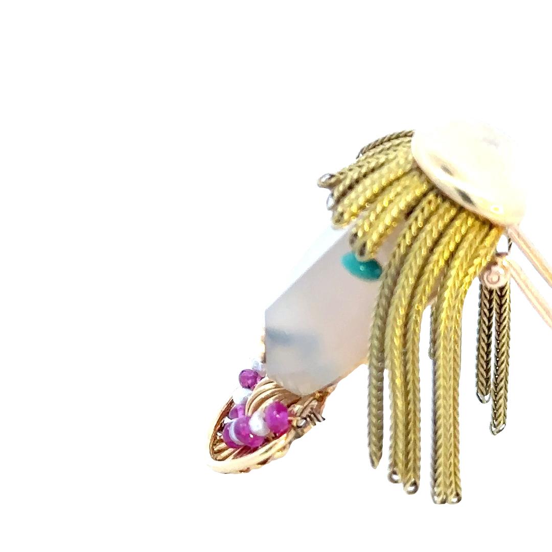 A captivating and unique piece of vintage jewelry: an 18-karat yellow gold French vintage woman figure brooch adorned with a necklace of rubies and pearls and featuring gold hair. This brooch is a true work of art, combining craftsmanship,