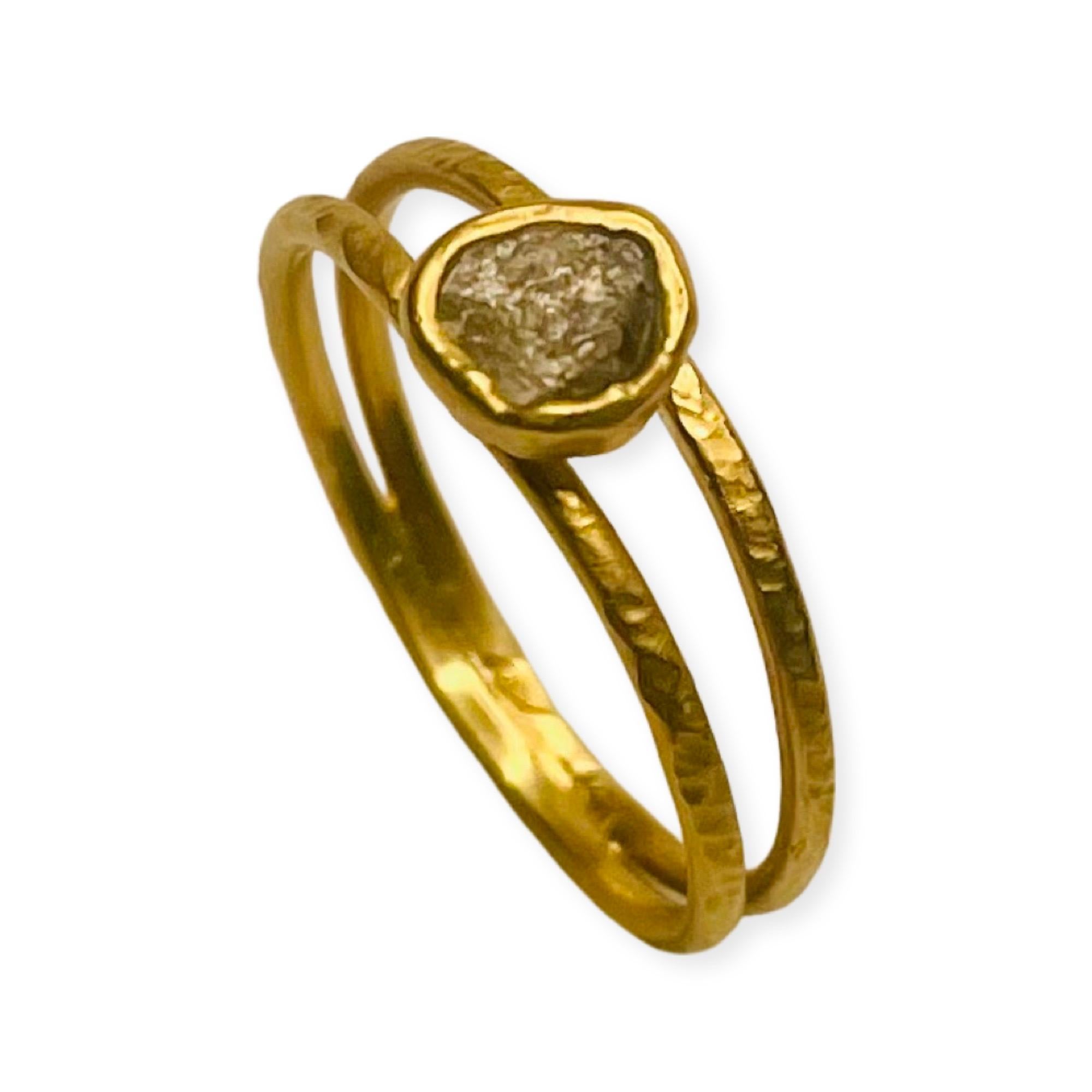 This is an 18KY gold, double banded, sapphire ring.  It is hand fabricated. The natural sapphire is a rough stone mined in Phillipsburg, MT at Gem Mountain. It is untreated. The top bezel measures 4.48 mm x 2.22 mm. The sapphire weighs 0.64cts. The