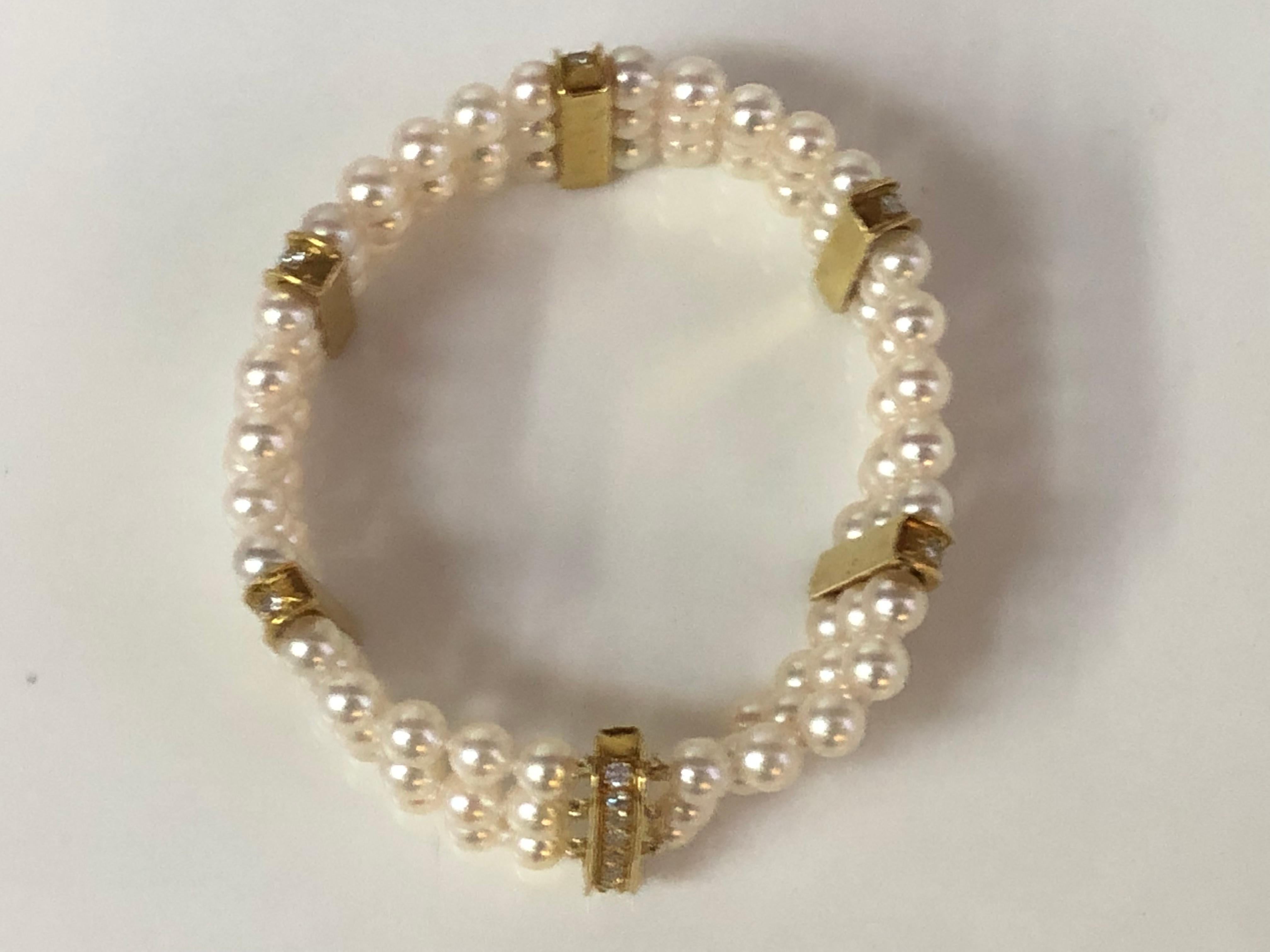 This stunning three strand pearl bracelet with six diamond stations is beautifully classic.
18 karat yellow gold clasp and diamond stations.
6 diamond stations approximately 18.5mm x 4.2mm overall, one is a hidden slide clasp.
48 round diamonds, 8