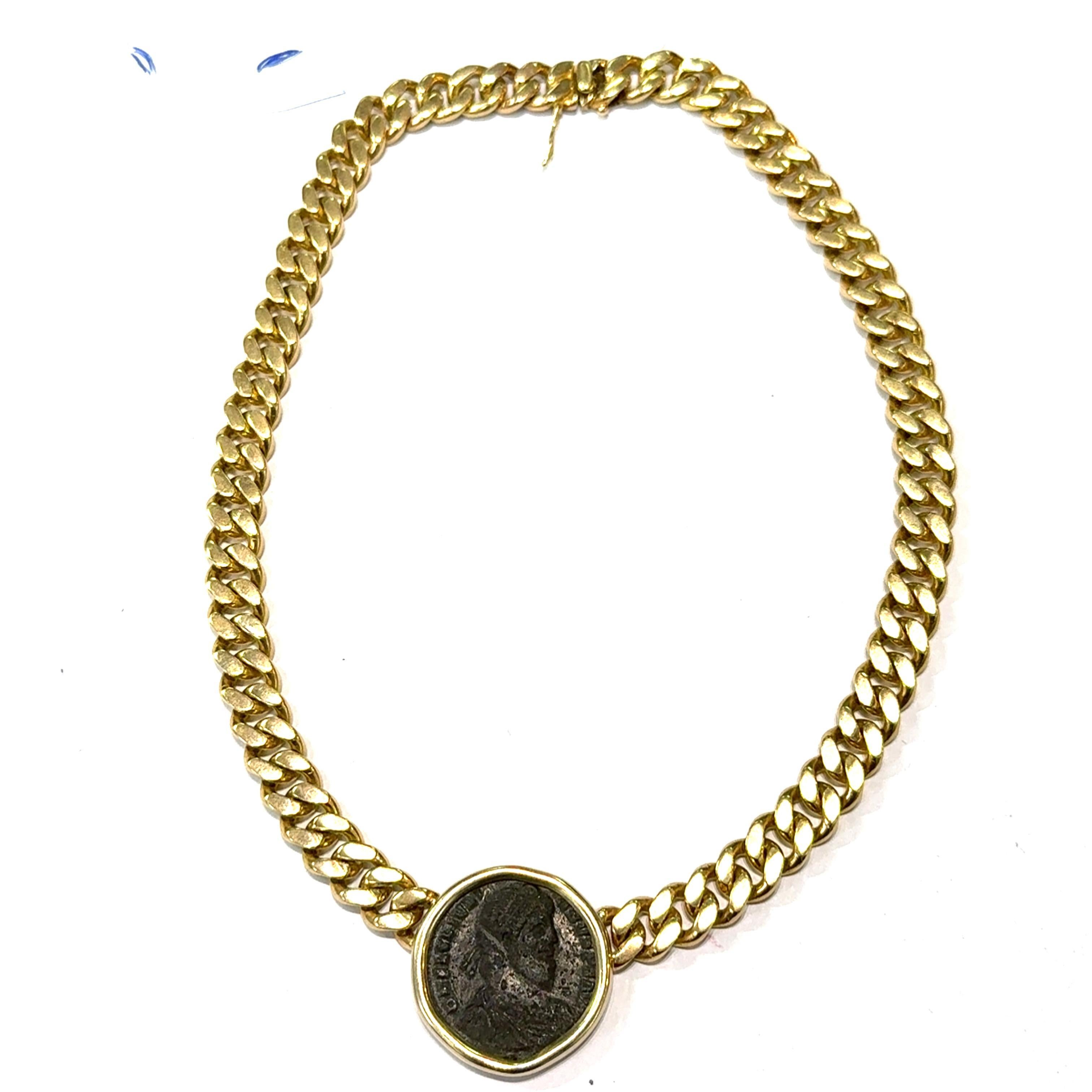 This necklace by Bvlgari is a striking piece, meticulously crafted in yellow gold. The design features a bold, chunky chain that exudes a sense of strength and luxury. At its center, a round medallion adds a unique focal point, seamlessly integrated