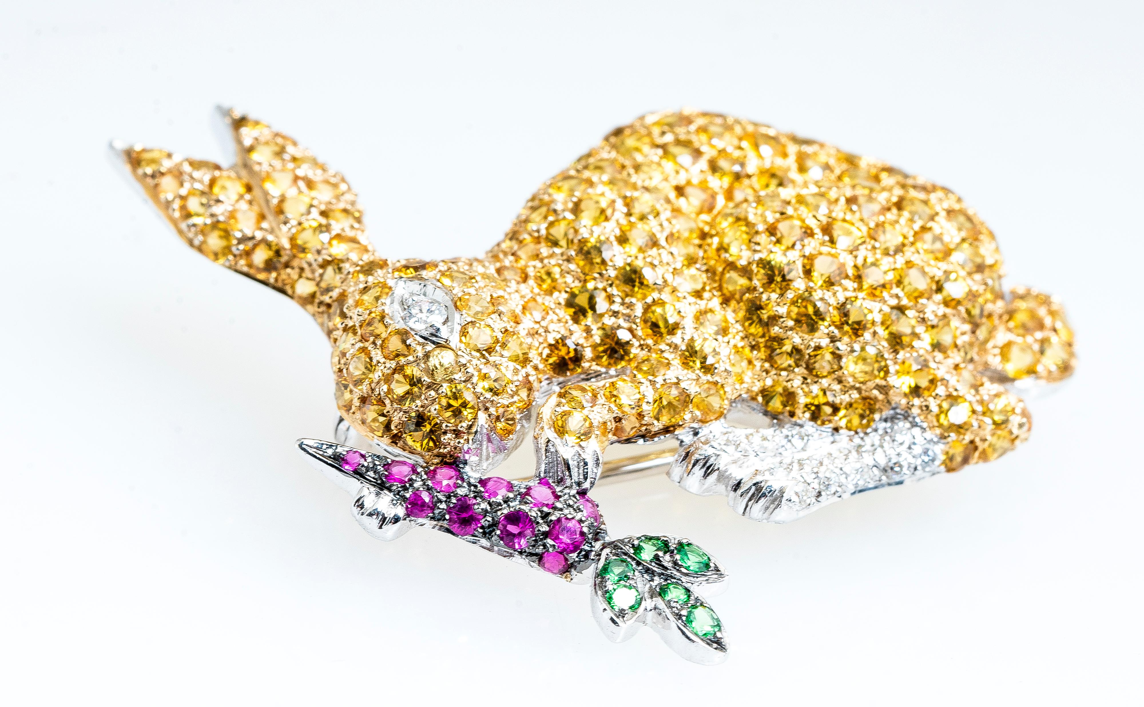 Vintage 18ky yellow sapphire, diamond, ruby and tsavorite bunny rabbit eating a carrot brooch/pin.   The rabbit body is made up of pave yellow sapphires and round diamonds for the eyes and feet.  The carrot is pave rubies and tsavorite for the green