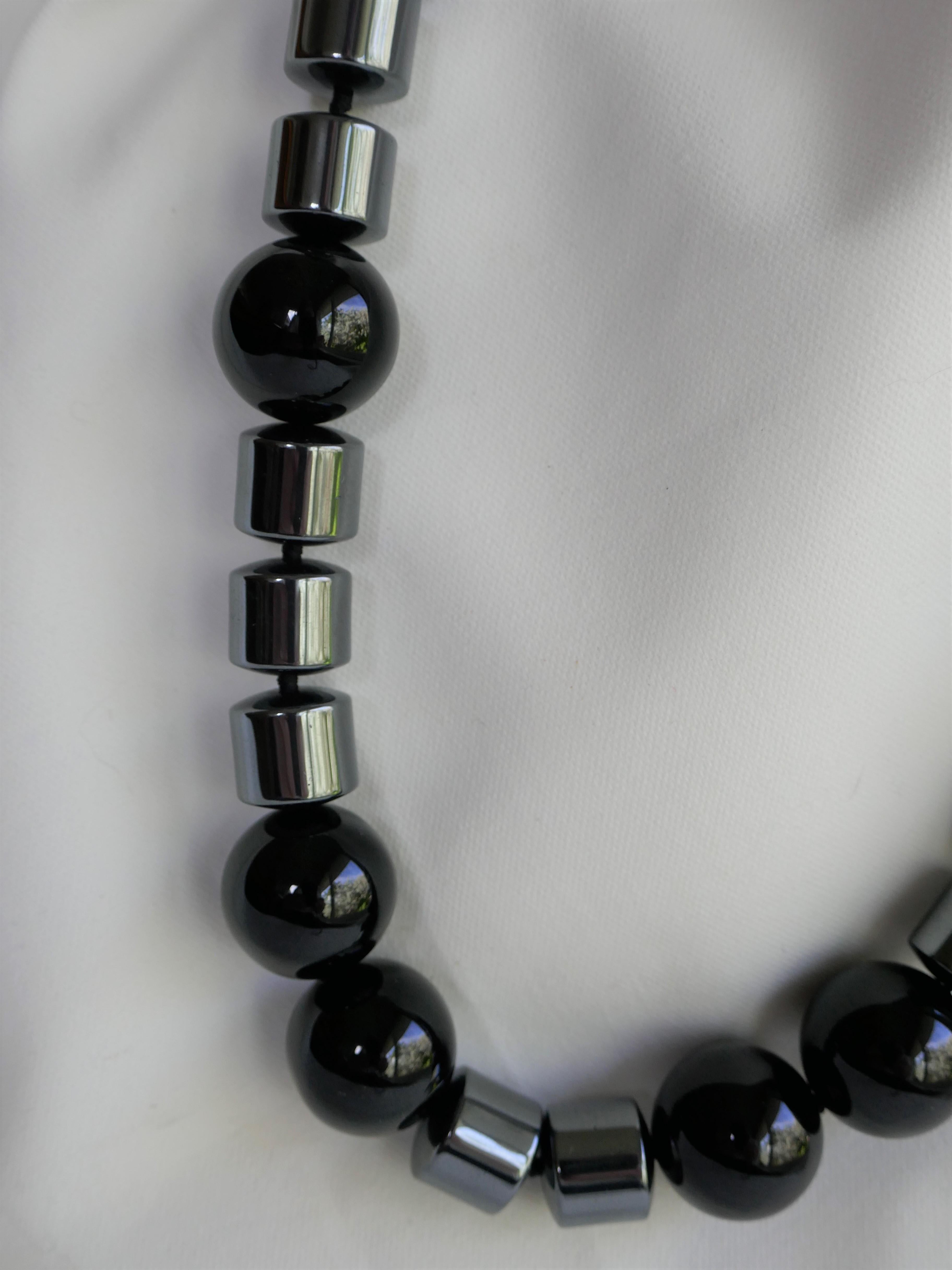 This 18mm black onyx and 12mm barrel hematite make a beautiful combination. The necklace is very neutral and easy to wear. It is a classic, modern and a statement necklace.  It is individually knotted with black silk thread. The overall length is 21