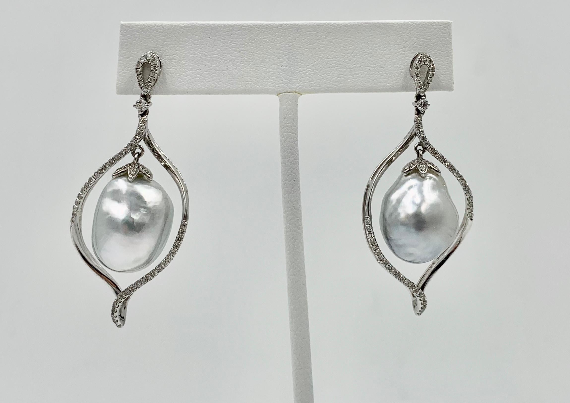 A magnificent pair of South Sea Pearl Diamond Dangle Drop Earrings with spectacular 18mm South Sea Pearls.  The impressive Pearls hang from a diamond set surround in 18 Karat White Gold.  There are a total of 126 sparkling white diamonds.  The