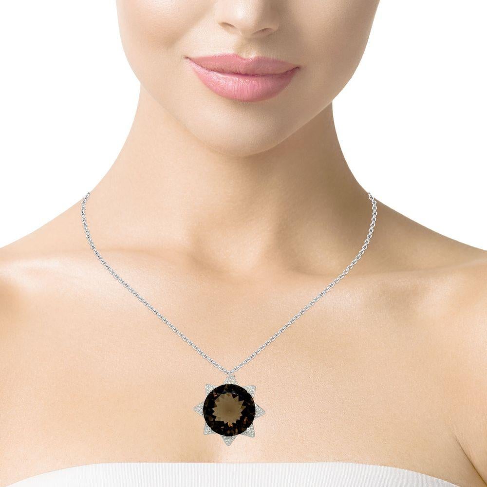 This stunning Star shaped pendant has a top quality 18x18mm round top quality deep brown Smokey Topaz with 4 prong setting in 14 karat white gold. There are 88 shimmering brilliant cut diamonds all round the stone for a delicate accent. This pendant
