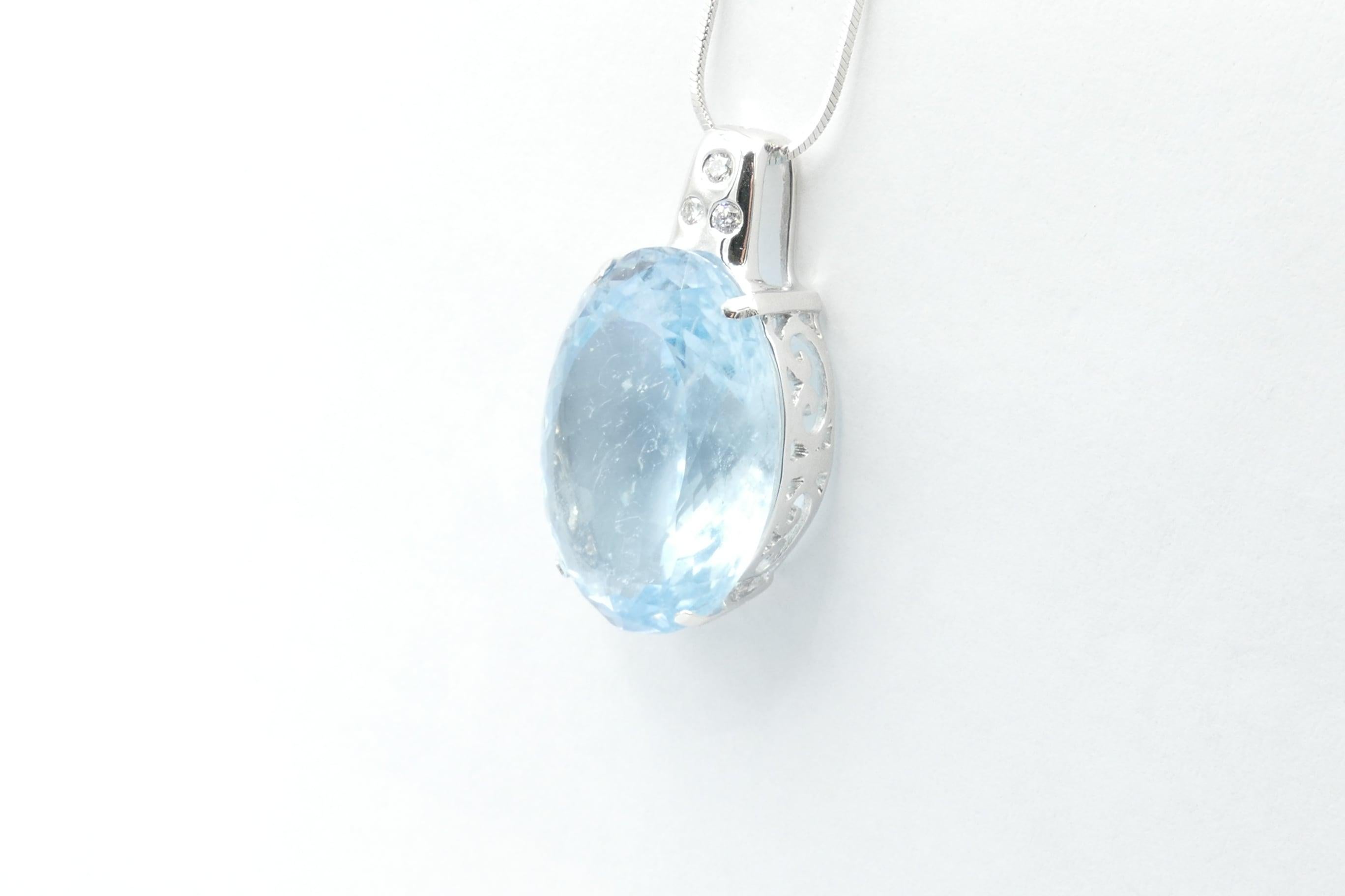 This very high quality Aquamarine pendant Pendant weighing over 28 carats & measuring 23.73mm X 17.58mm X 11.79mm is
 light - mid blue in Colour, Tone medium, Clarity eye-clean, Oval Cut, 4 Claw Set.
It has 3 Round Brilliant Cut Diamonds, Colour