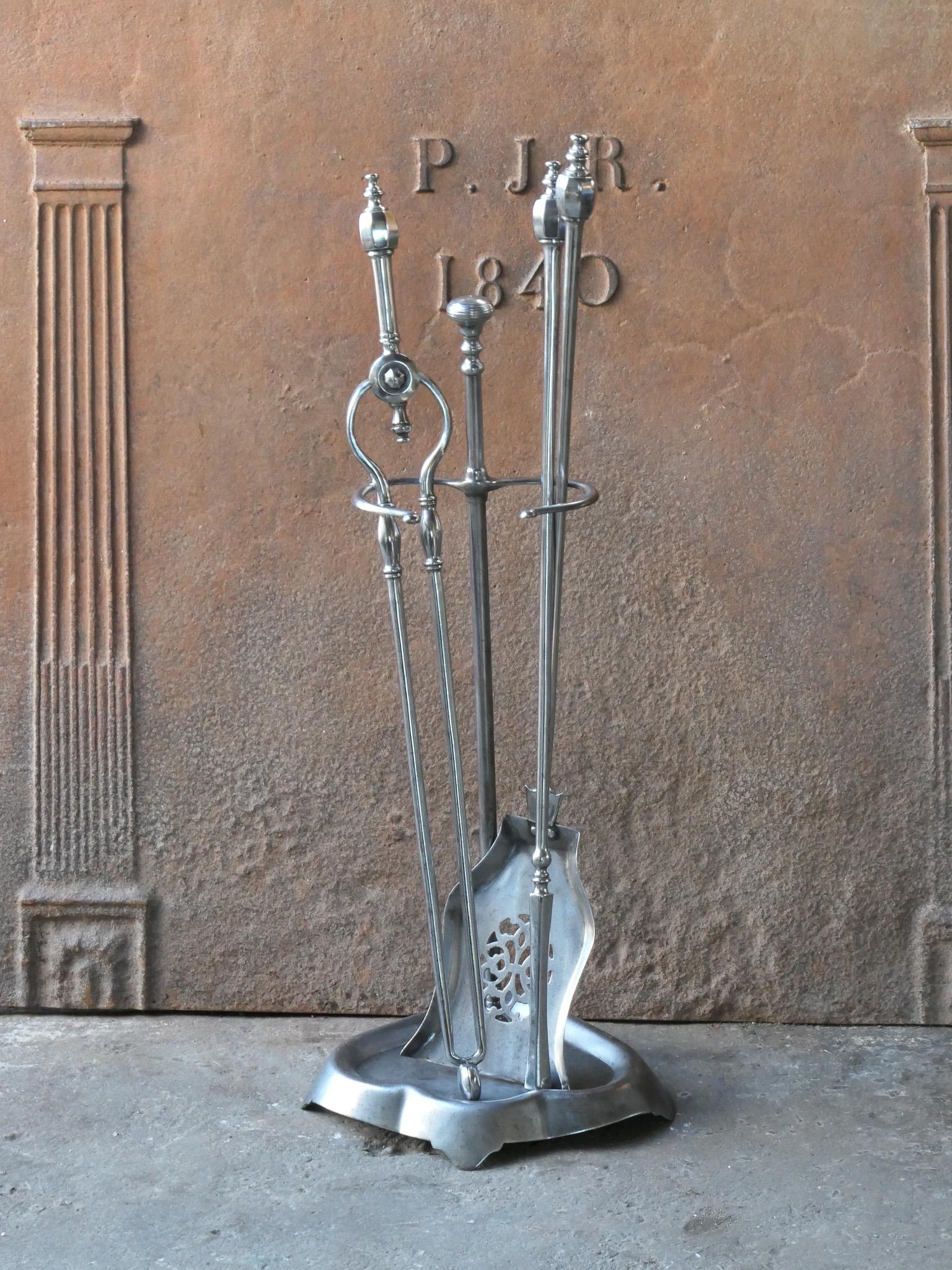 18/19th century English Georgian fireside companion set. The tool set consists of thongs, shovel, poker and stand. Made of polished steel. It is in a good condition and is fully functional.