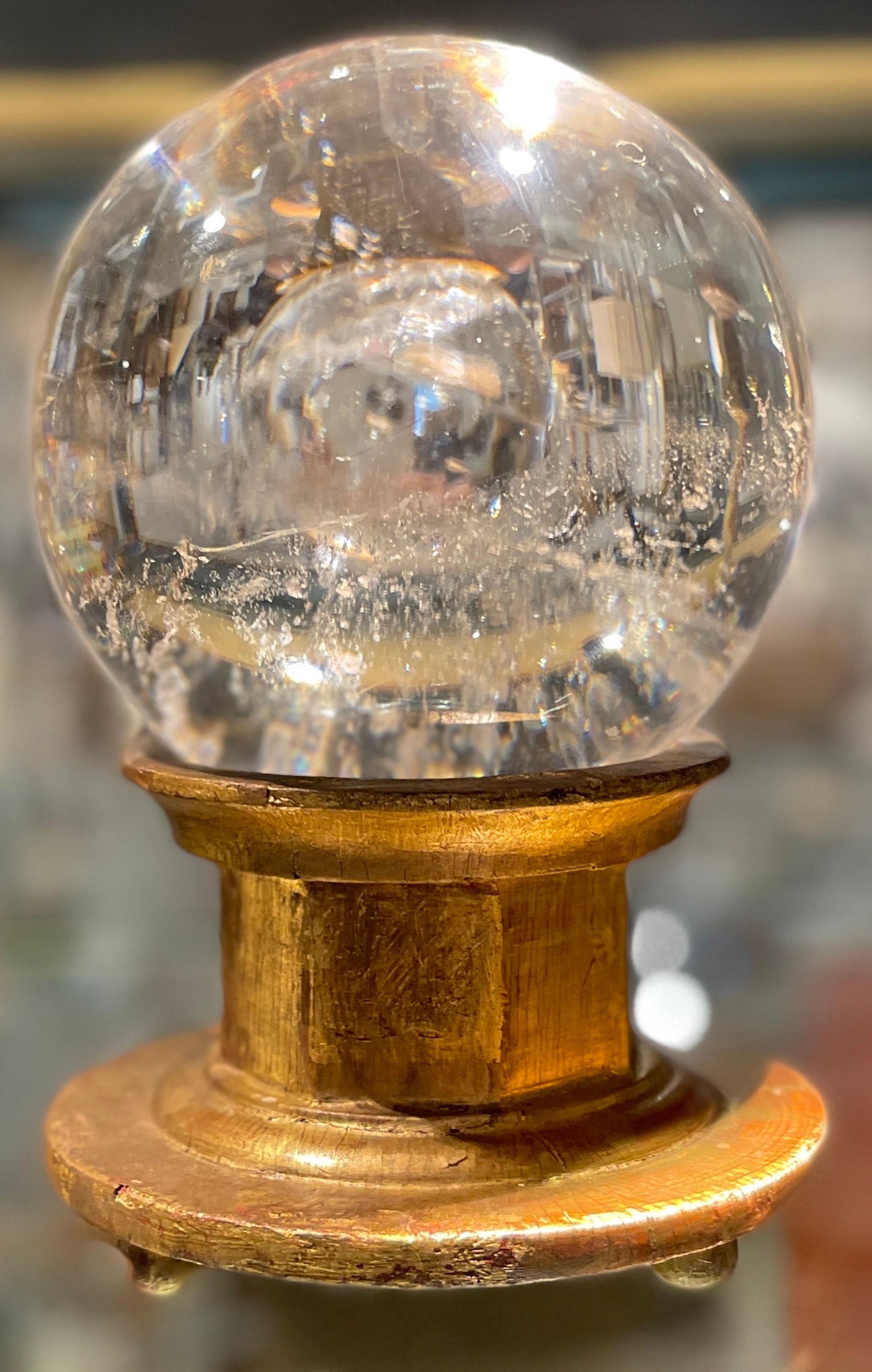 18th-19th C. Italian rock crystal ball/orb on a later Italian giltwood stand, in two parts
The rock crystal ball/ orb European possibly French or Russian
The stand early 20th century carved giltwood and polychromed pedestal base.

A magnificent