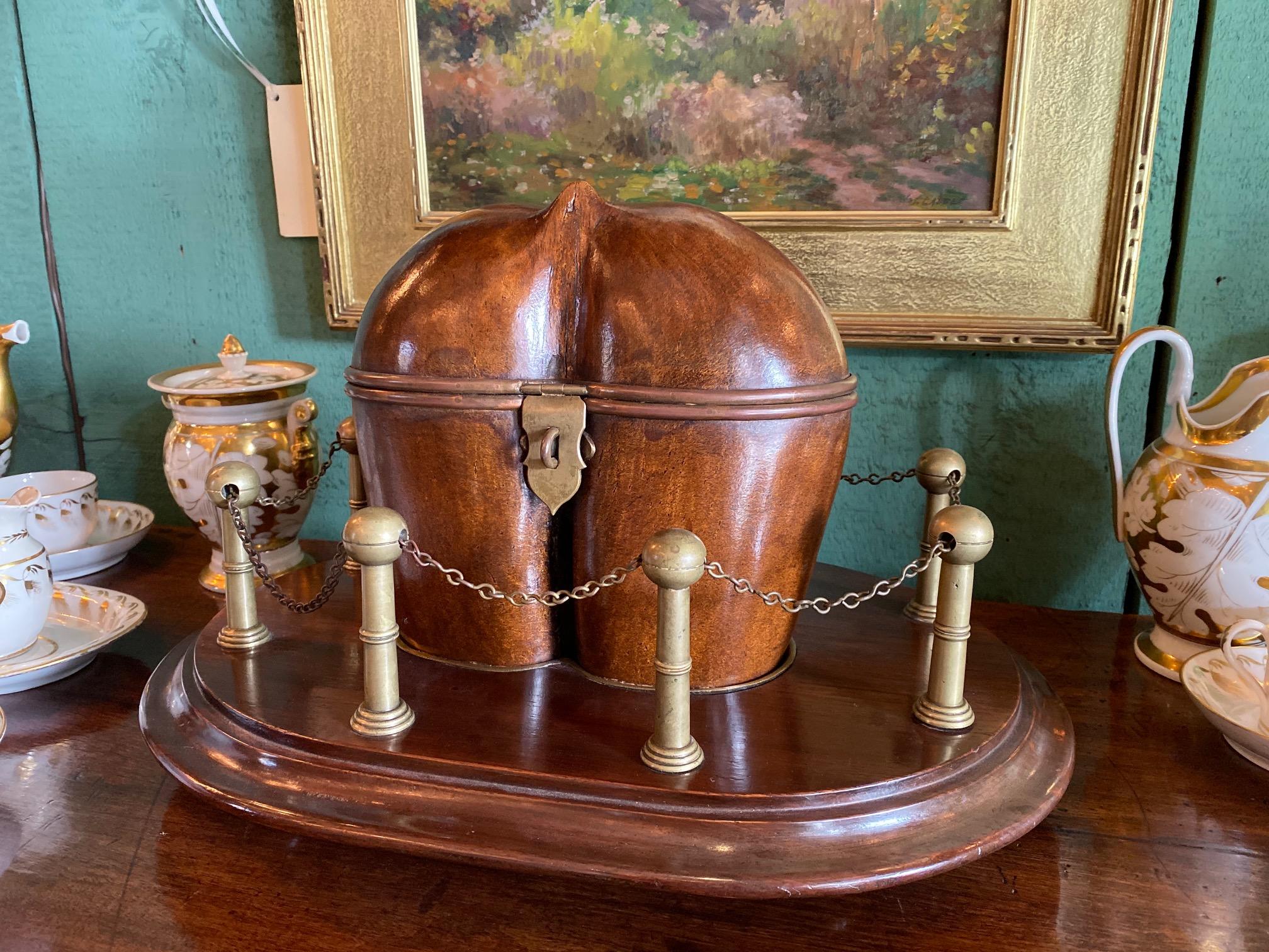 Hand Carved Crafted Fruit Wood Coco Georgian Victorian Tea Caddy Centerpiece LA
Very rare 19th century George III to Victorian coco nut “Coco de Mer” palm nut tea caddy on a stand surrounded by Brass columns and chains. The brass on the Nut itself