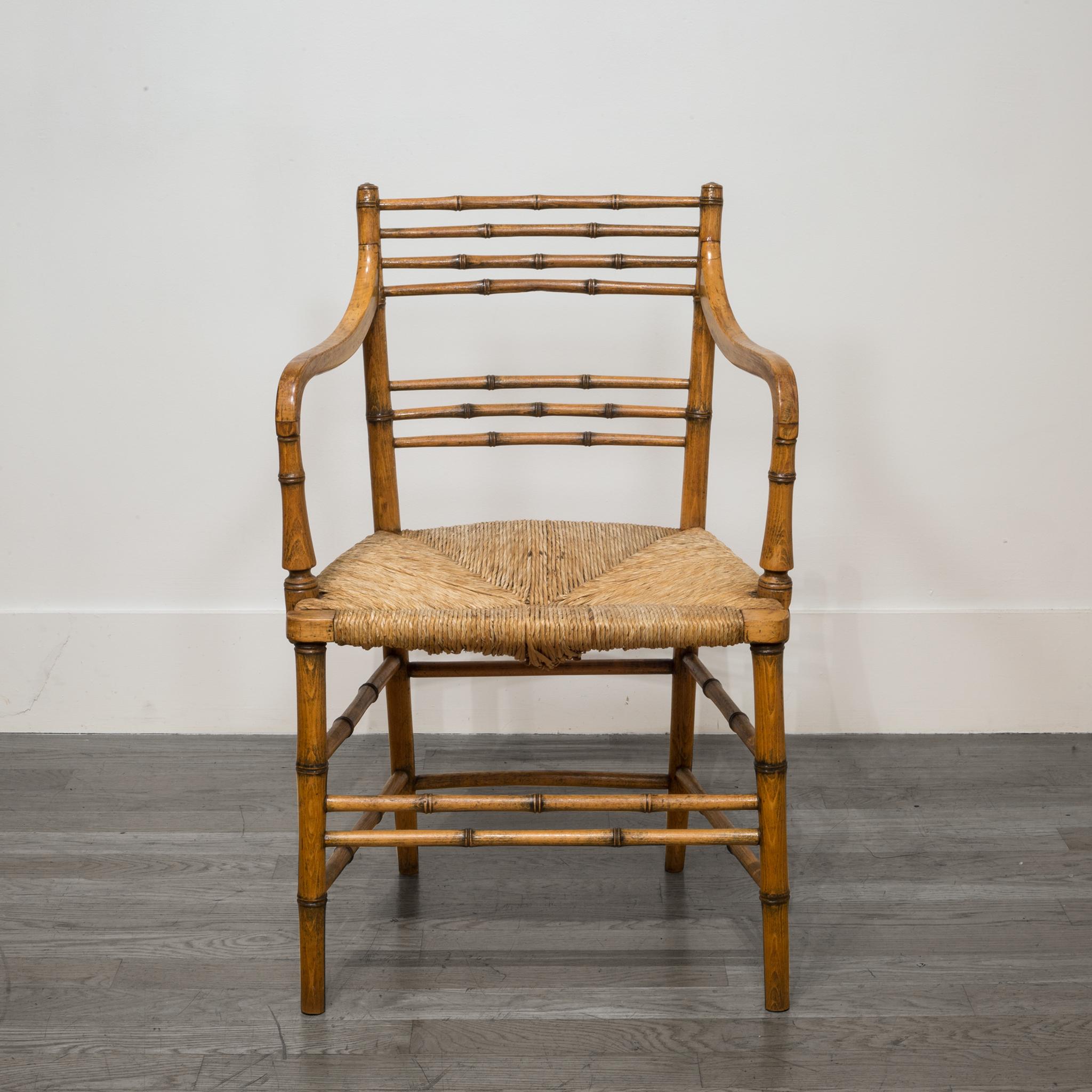 Faux bamboo Regency armchair made of beechwood with the original rush seat.