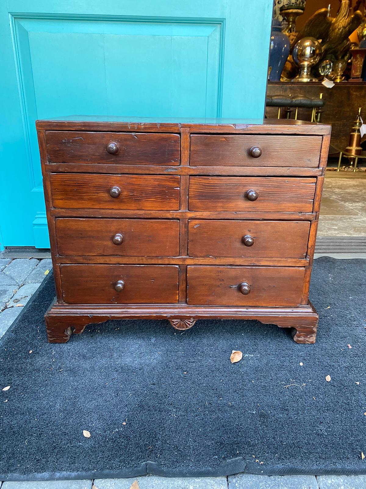 18th-19th century American pine miniature chest with eight drawers.