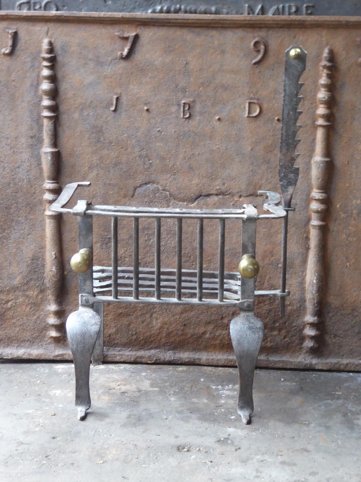 18th-19th century Belgian neoclassical fireplace grate made of cast iron. The fireplace grate is in a good condition and is fully functional.