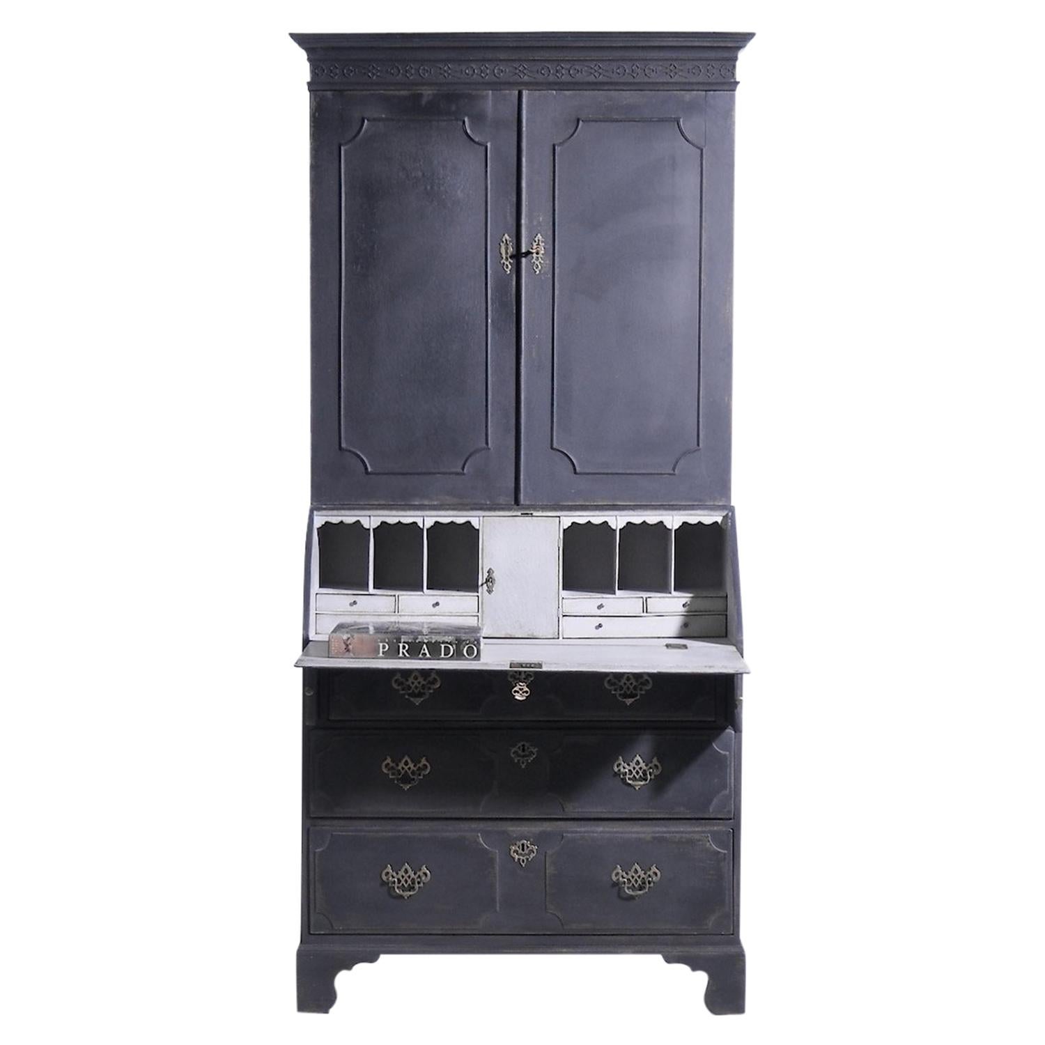 A 18th - 19th Century, black, antique Swedish Gustavian two part bureau with a writing flap made of hand crafted Pinewood, in good condition. The Scandinavian secretaire is composed with two doors, three large drawers and many small storage spaces,