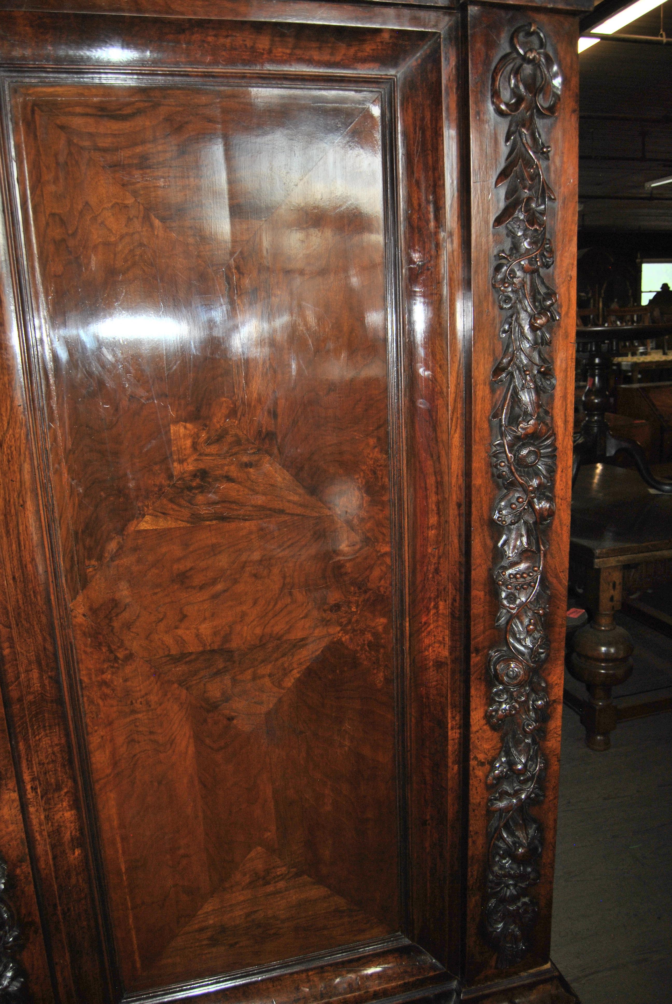 This is a fabulous quality, very unusual mahogany 2-door armoire made in France, circa 1800. The crown on the top of the Armoire is well layered and very bold. There is a remarkable hand carved medallion on the front top of the Armoire. It is deeply