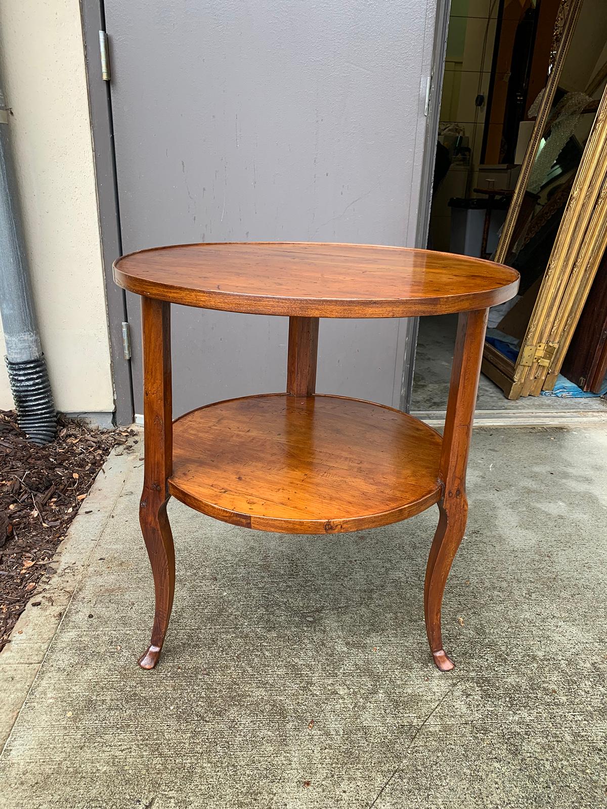 18th-19th century Continental round wood two-tier table with hoof feet.