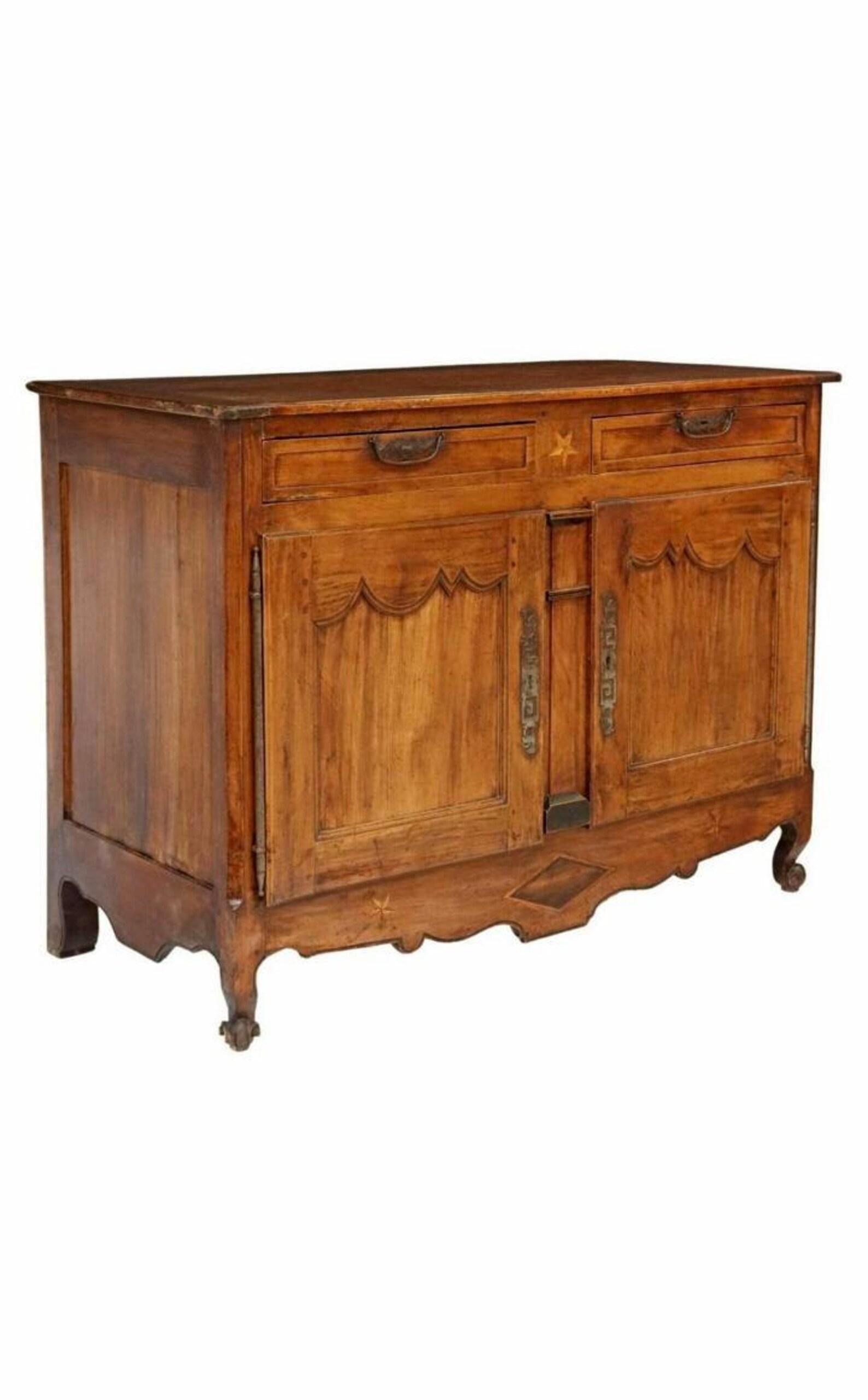 A country French Provincial Louis XV style antique, circa 1790-1820, star inlaid walnut enfilade with beautifully aged warm rustic patina.

Hand-crafted in France over 200 years ago, featuring the original plank top with breadboard batten ends and