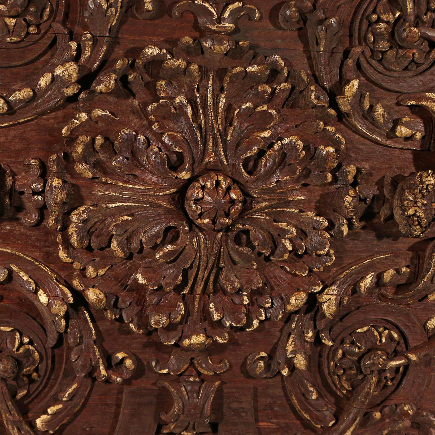 A large dark brown Italian ceiling panel made of hand carved walnut, enhanced with caryatid and acanthus scrolls, in good condition. The antique wall relief, décor represents the Rococo time period. Wear consistent with age and use, circa 1790-1810,