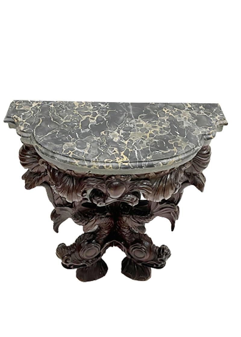 18th-19th century dolphin console table with marble top

A hand carved oak console table with dolphins from the late 18th, early 19th century with 2 tops. The bottom layer of stone and the top layer of marble

The marble top is professionally