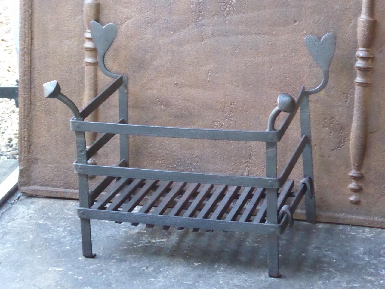 18th-19th century Dutch Louis XV fireplace grate. The grate is made of wrought iron and has a black color. Our blacksmith has forged a new bottom for the grate.








 