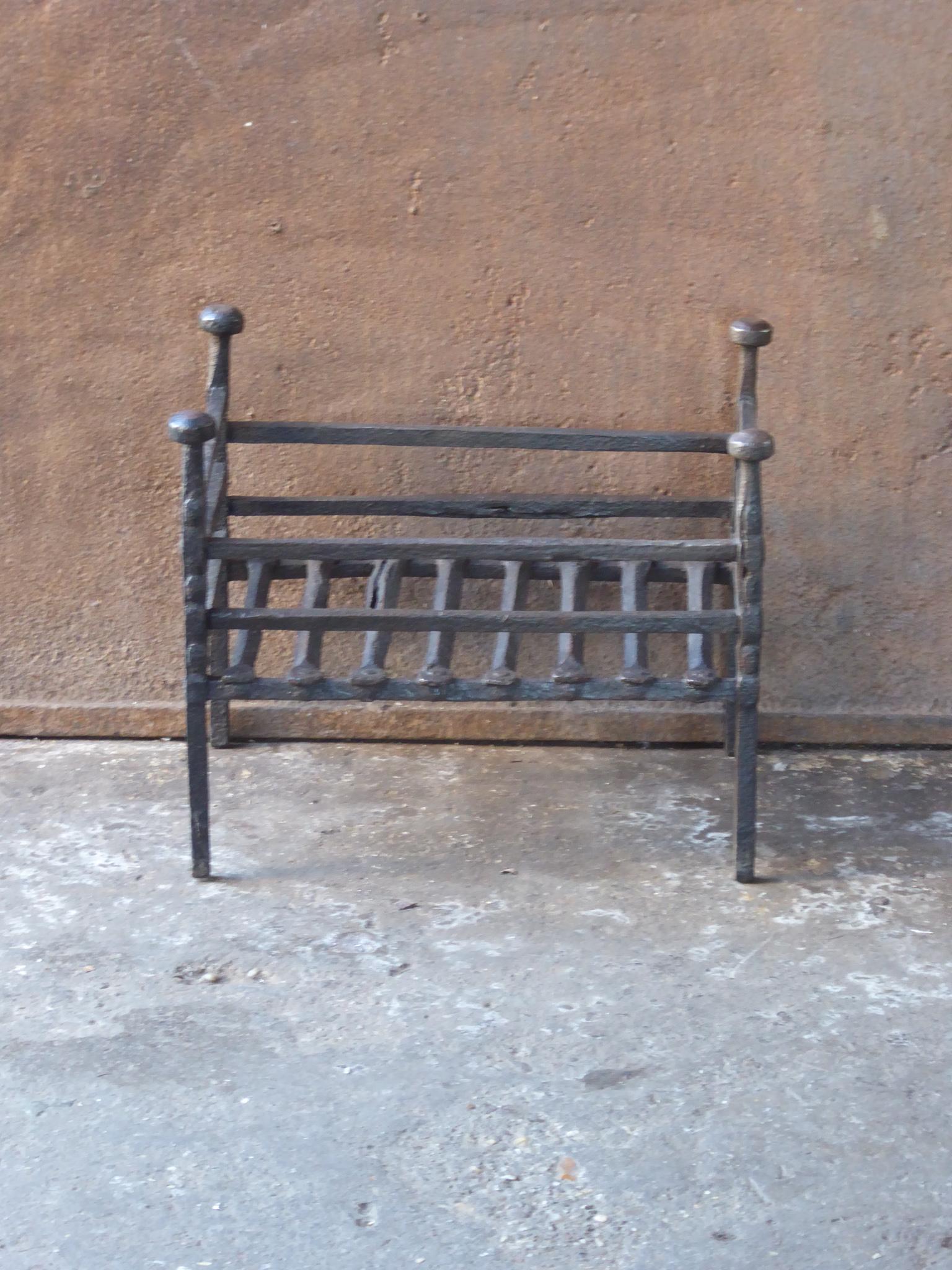 18th-19th century Dutch neoclassical period fireplace grate made of wrought iron. The fireplace grate is in a good condition and is fully functional.
