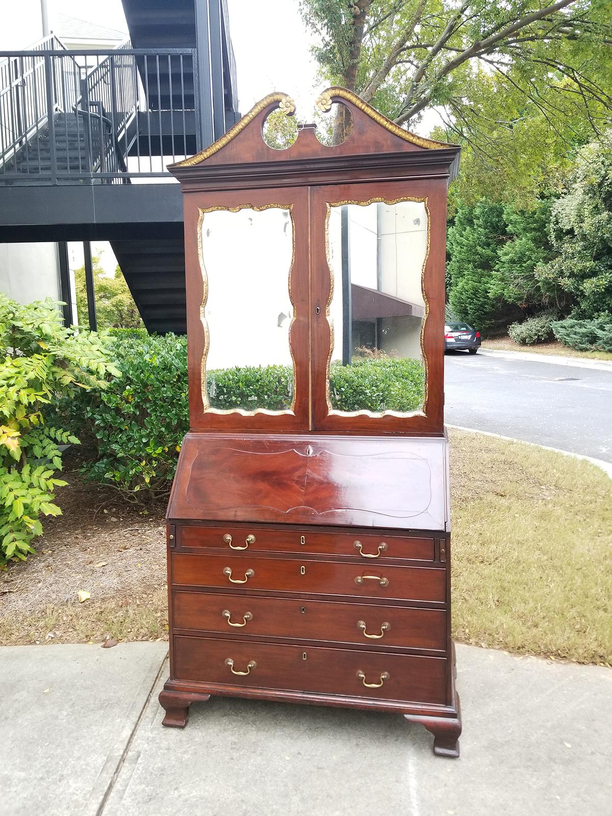 18th-19th century English George II mahogany and parcel-gilt bureau secretary and bookcase with mirrored doors.