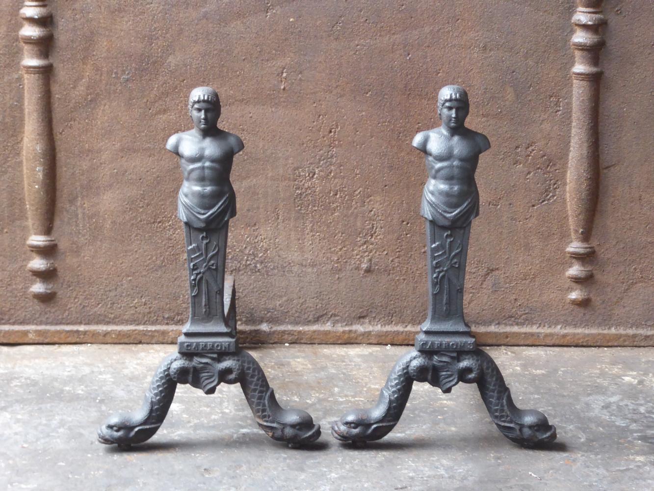 18th-19th century English Georgian andirons made of cast iron and wrought iron. The andirons are made in the famous Scottish Carron Foundry. They have a black patina.















         