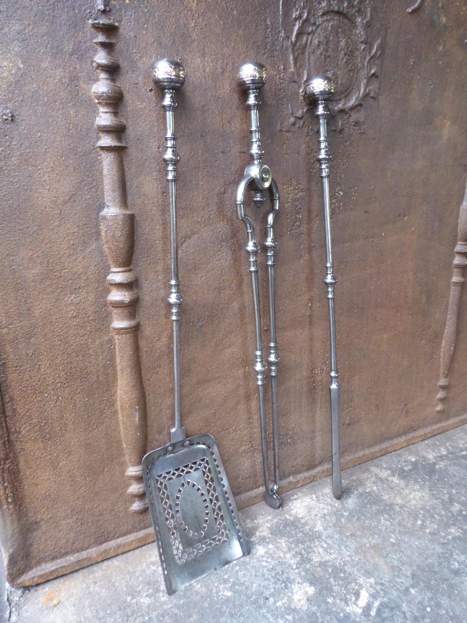 Ornate set of of three Georgian fireplace tools ring banded shafts, round knopped finial handles with bronze inlays and a finely pierced & cut shovel. The set is made of polished steel with polished bronze. The fire tool set is in a good condition