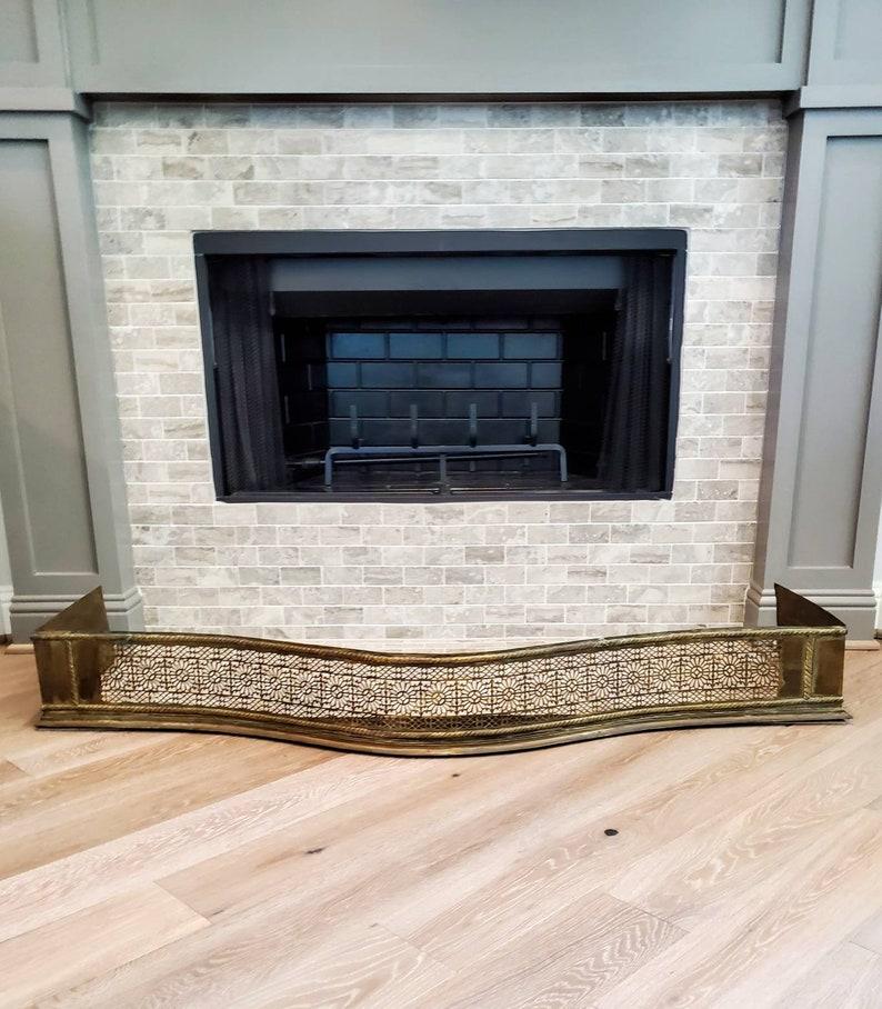 A large, over five foot long, antique Georgian pierced brass fireplace hearth fender with beautifully aged patina. Create a stunning focal point with this beautiful ornament! Hand-crafted in England, the elegant Georgian III period (c.1760-1820)