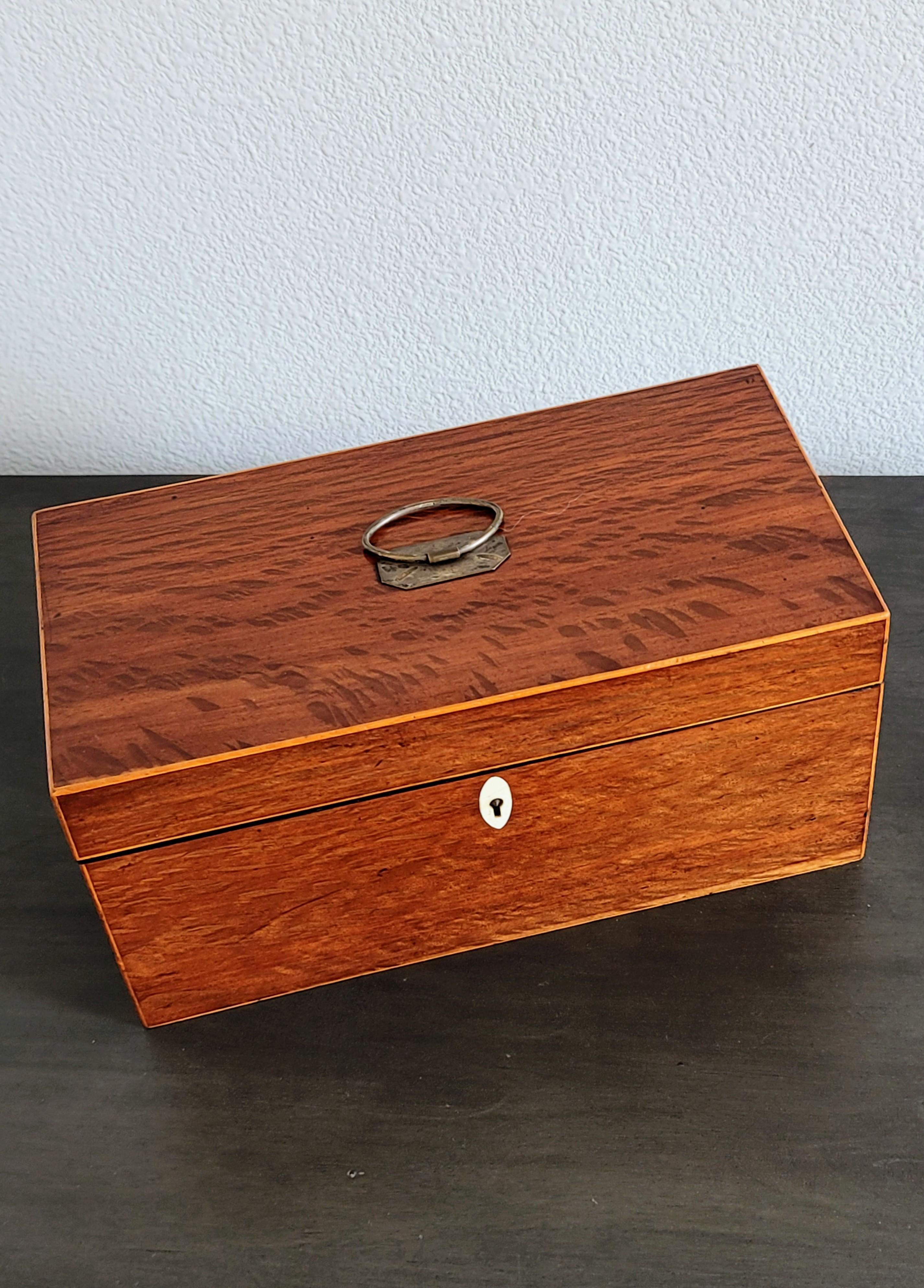 A fine quality Regency Era / Georgian Period tea caddy set in sumptuous plum-pudding mahogany.

Exquisitely hand-crafted in England at the turn of the late 18th / early 19th century, featuring a well made solid wood case with clean straight lines