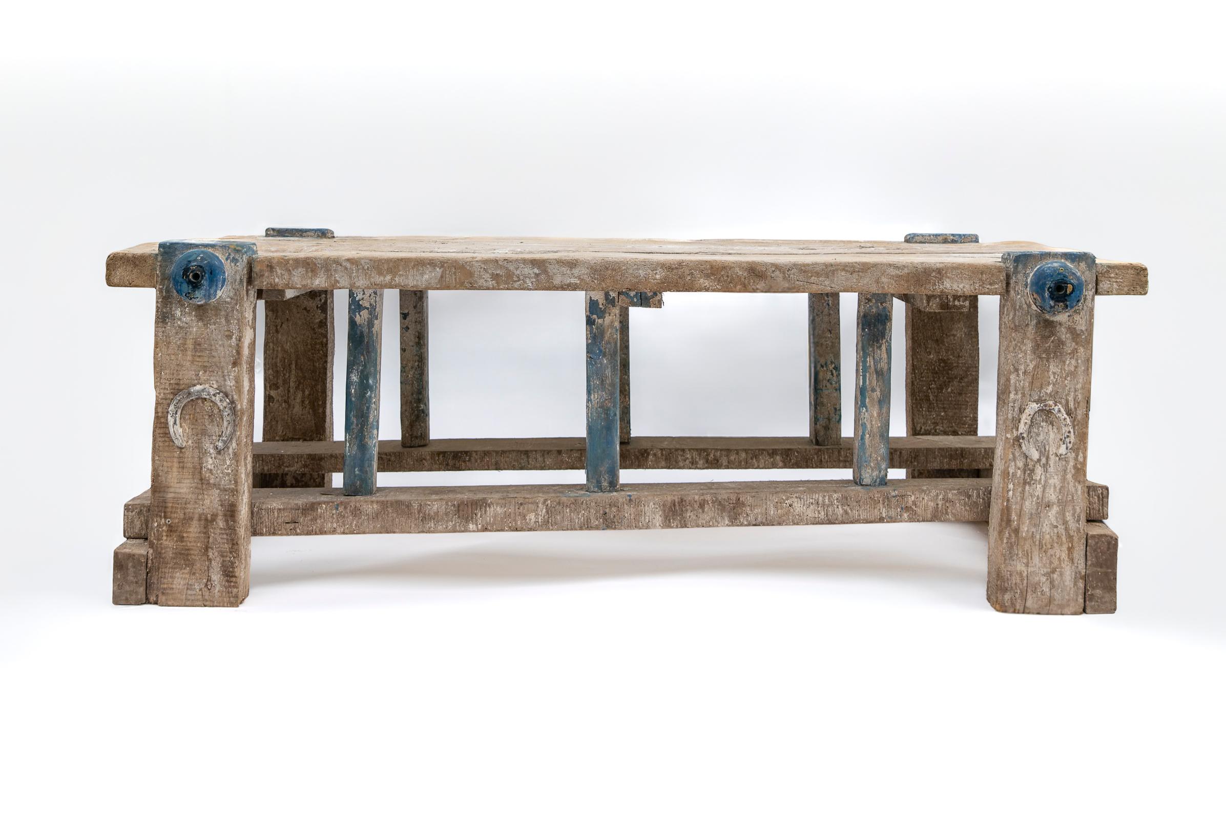 An authentic European relic of 18th-century craftsmanship, this substantial work table features a beautifully weathered wood surface that speaks to generations of use and history, likely used as a carpenter's work bench or table.  The piece's