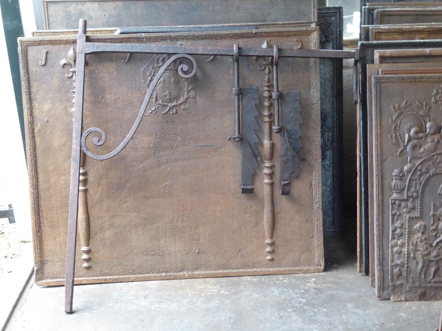 18th-19th century French fireplace crane made of wrought iron. The crane is still functional for cooking in the fireplace.







 
