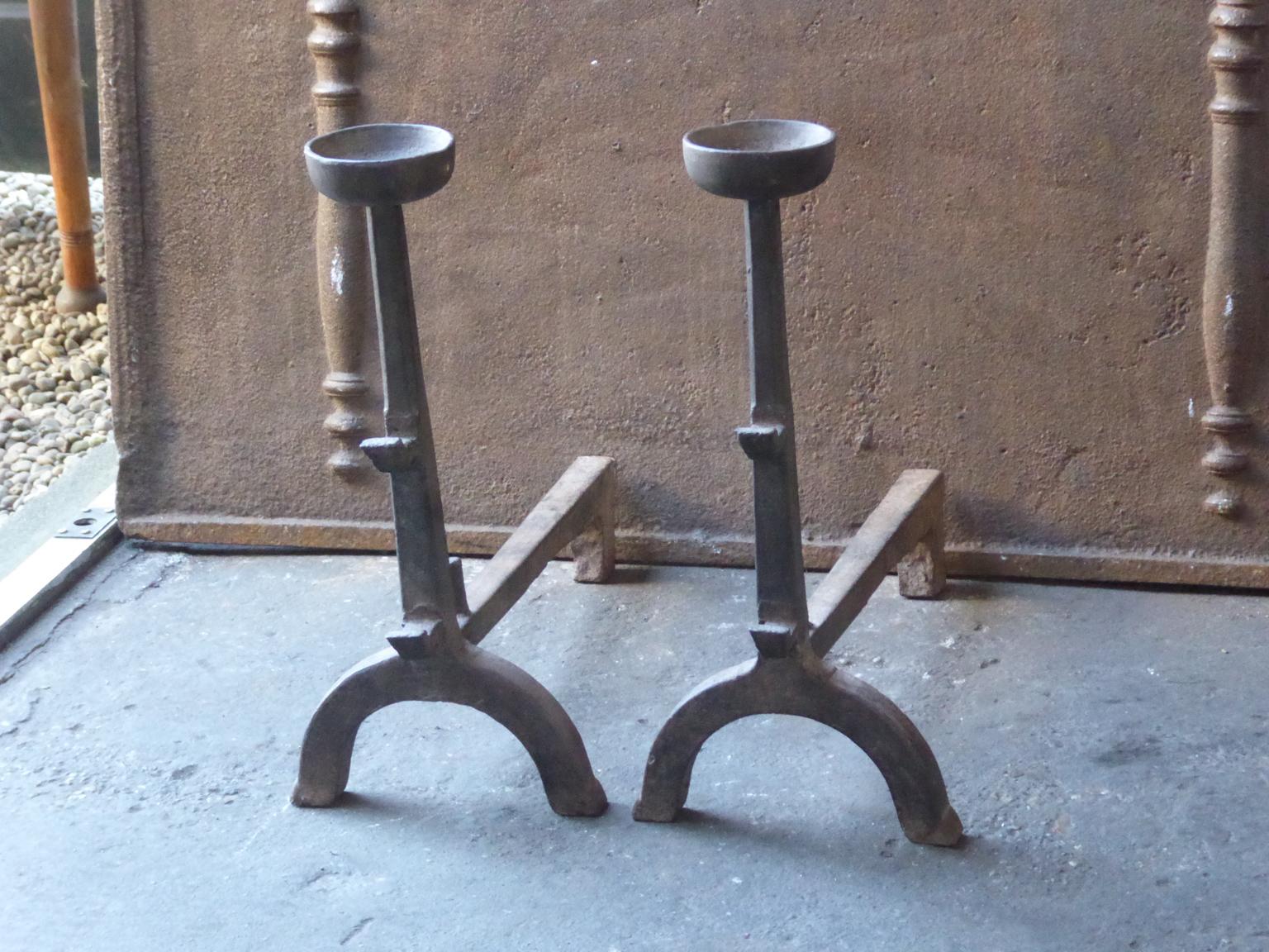 18th-19th century French Gothic style andirons made of cast iron. The andirons have spit hooks to grill food and cups to keep drinks warm. This type of andiron is therefore also called cup dogs.







 