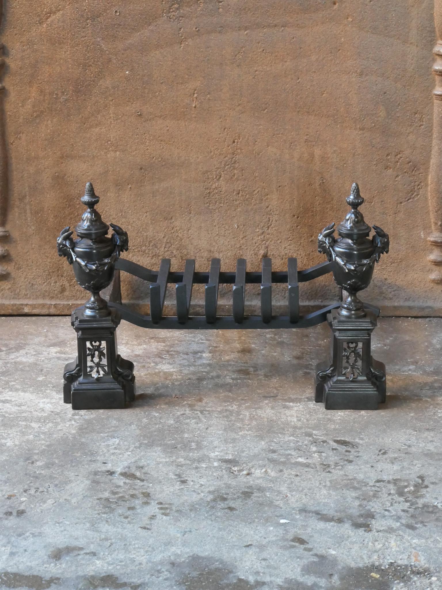 18th-19th century French Neoclassical fireplace grate made of brass and wrought iron. The fireplace grate is in a good condition and is fully functional. 






