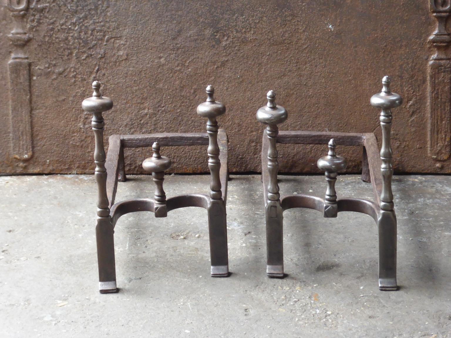 Late 18th or early 19th century French neoclassical period andirons. The andirons are hand forged and made of wrought iron. The condition of the andirons is good.

