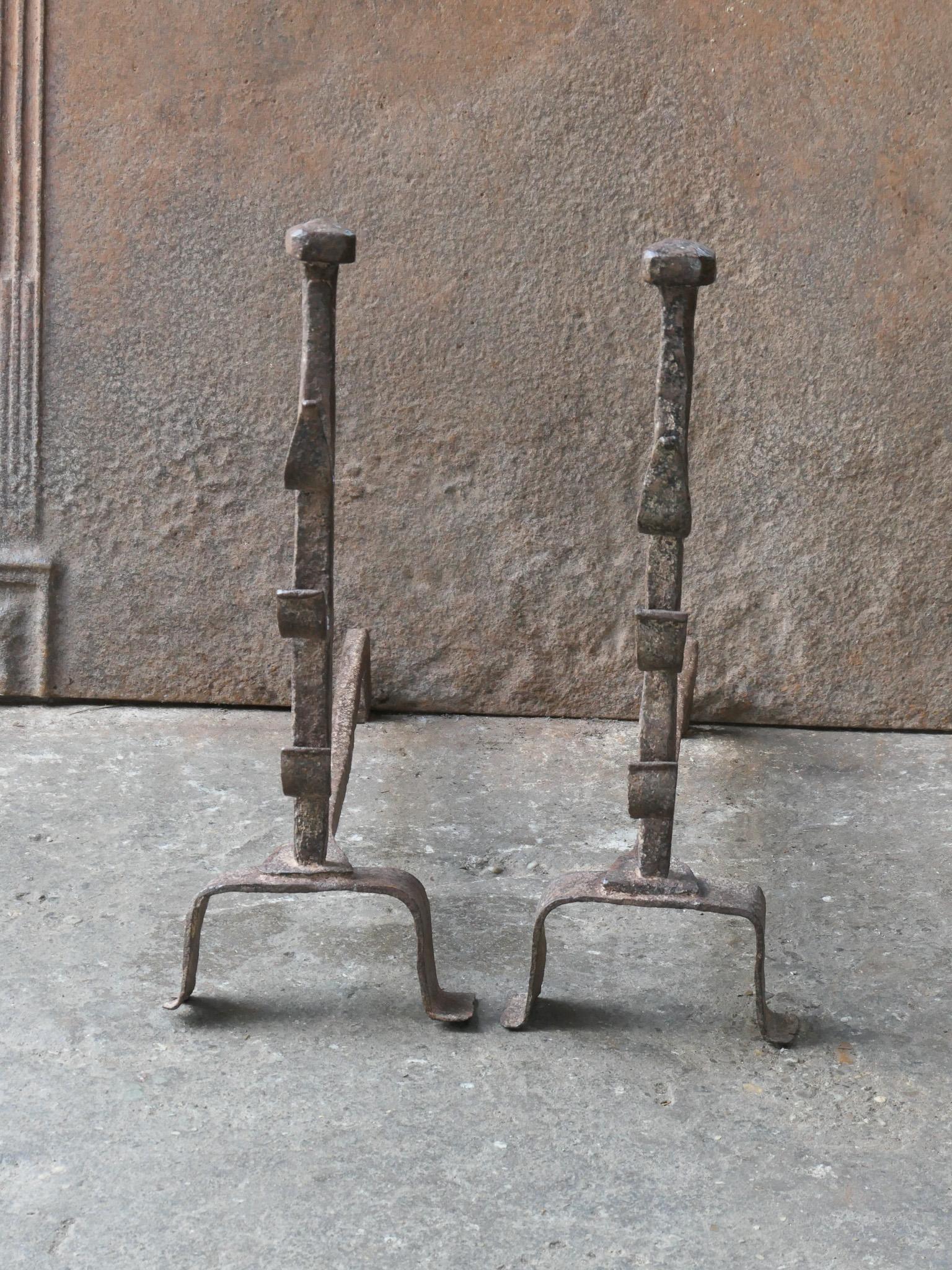Late 18th or early 19th century French neoclassical period andirons. The andirons are hand forged and made of wrought iron. The andirons have spit hooks to grill meat and poultry. The condition of the andirons is good.







 