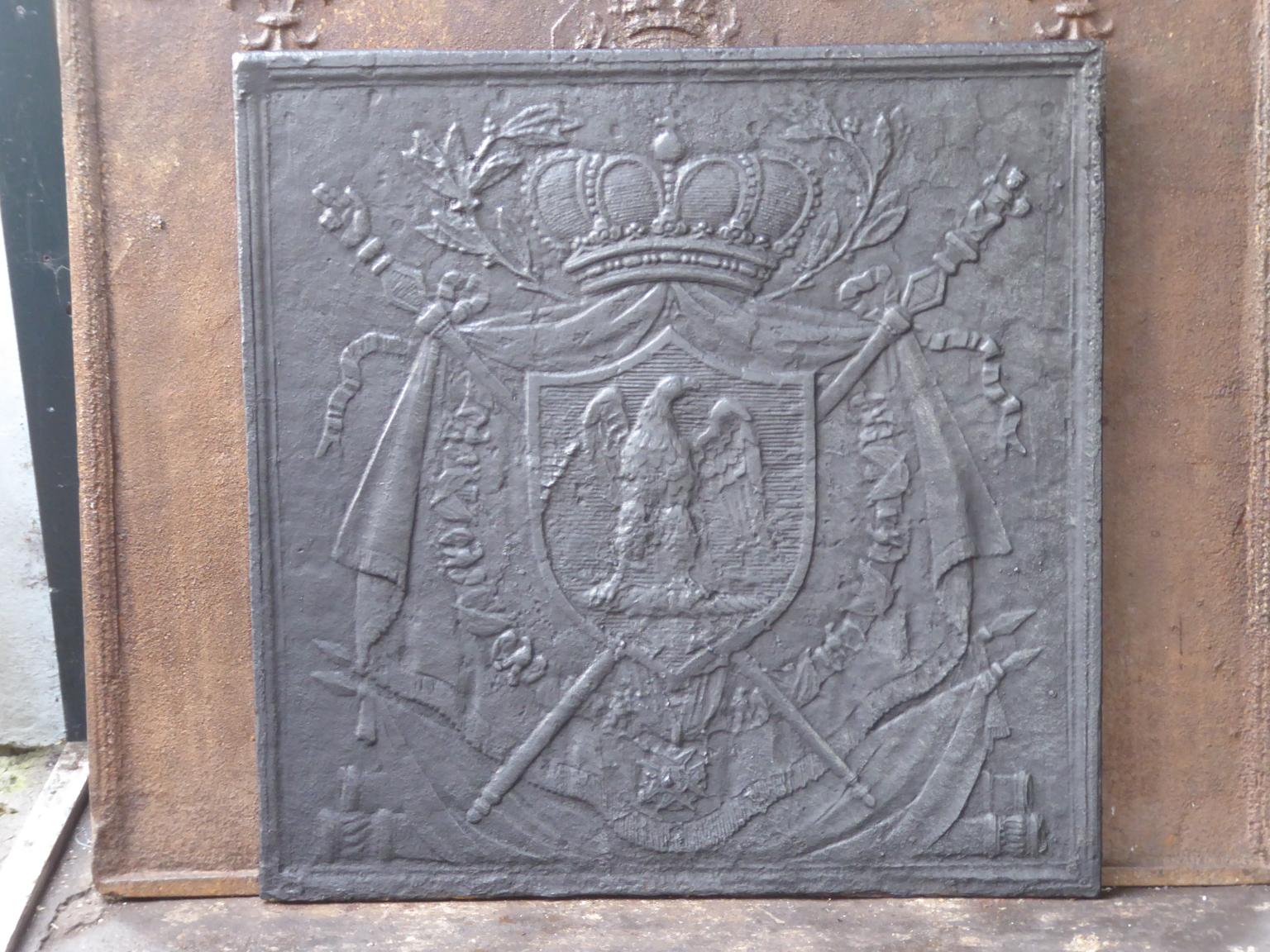 18th-19th century French neoclassical fireback with the eagle, coat of arms of Napoleon Bonaparte. 

The fireback is made of cast iron and has a natural brown patina. Upon request it can be made black. The fireback is in a good condition and does
