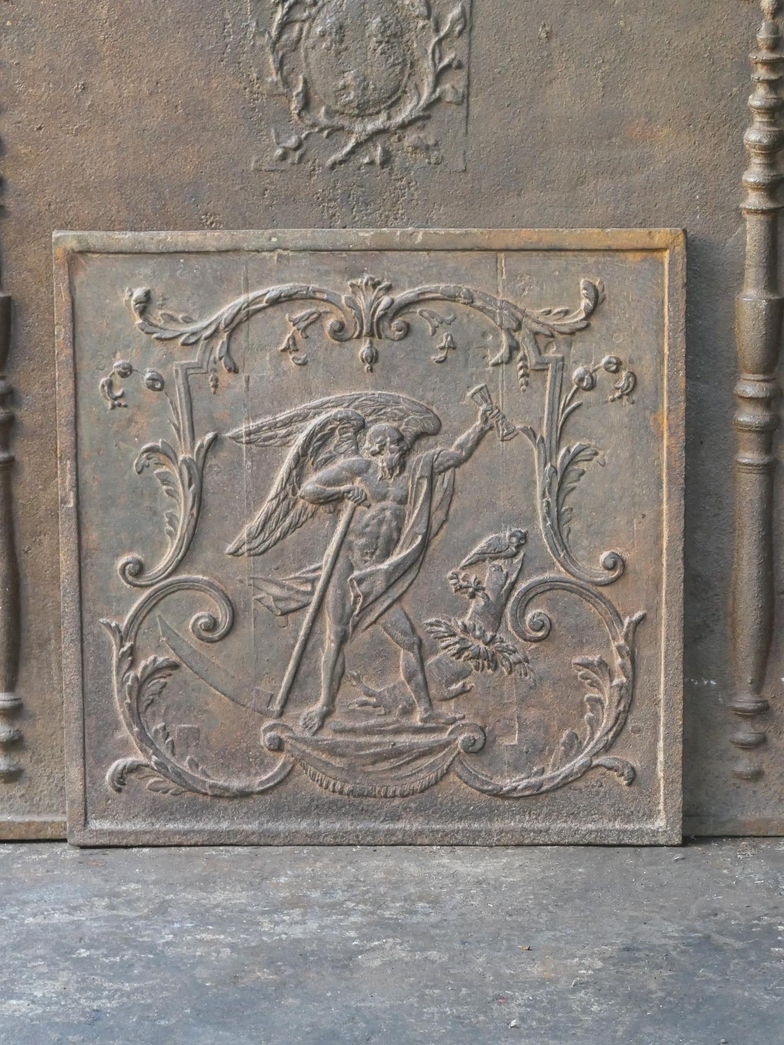 Late 18th or early 19th Century Neoclassical period French fire back with the time. The time, an old man with a scythe, symbol of the ephemeral character of life.

The fireback is made of cast iron and has a natural brown patina. Upon request it can