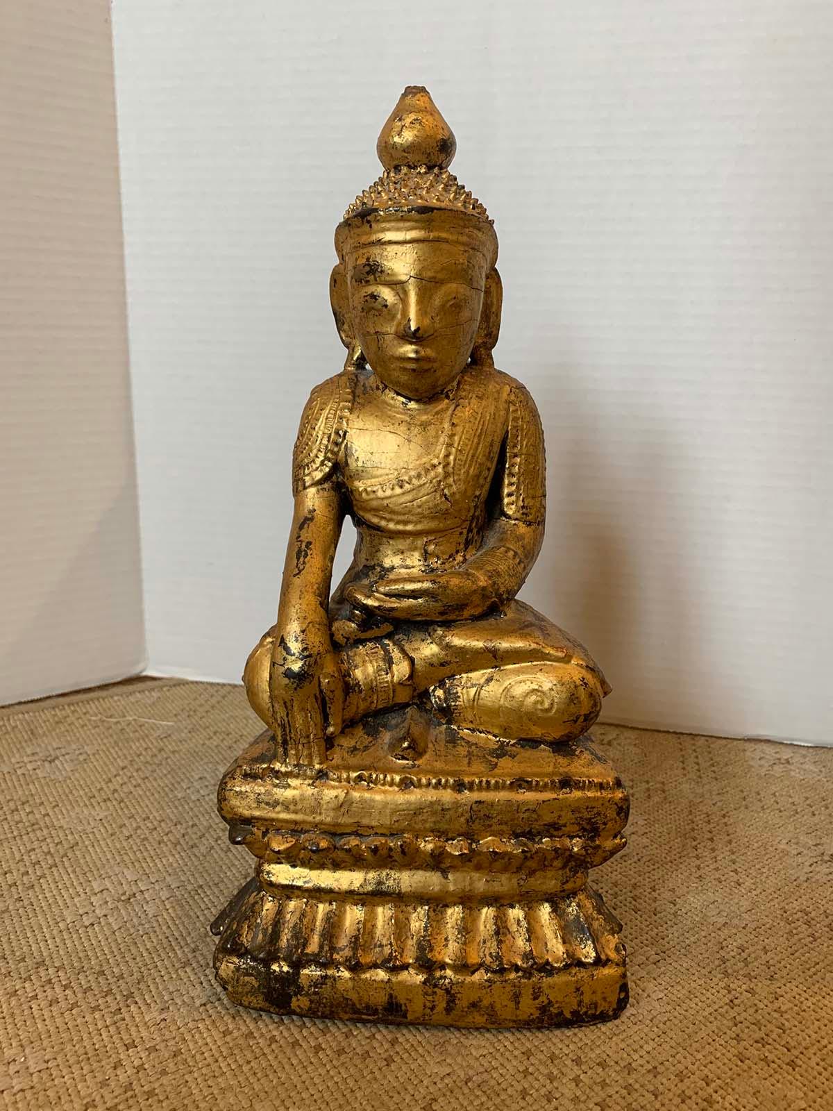 18th-19th century giltwood Buddha in lotus position.