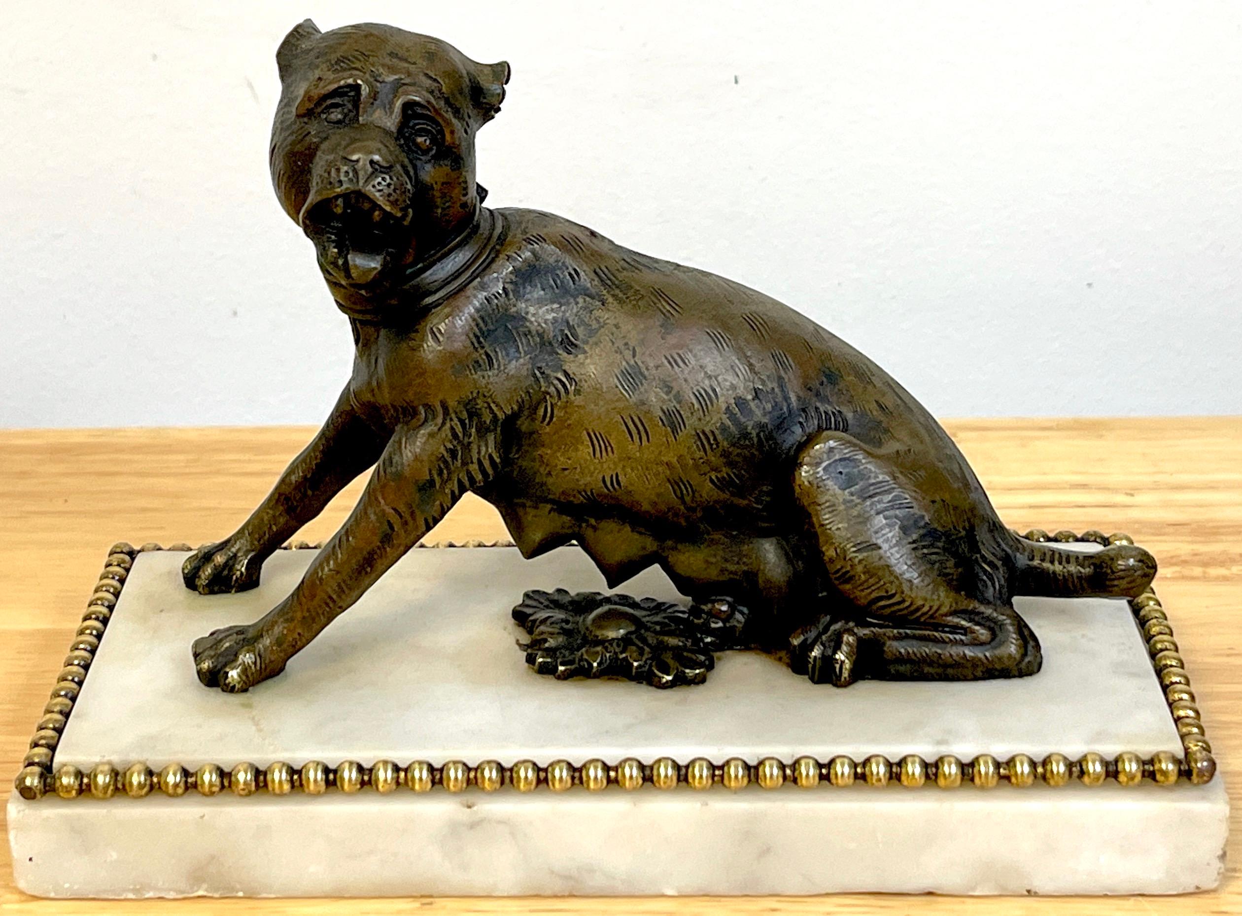 18th-19th ( or older) century Italian bronze sculpture of a seated she-wolf.
Similar to the Capitoline Wolf /Lupa Capitolina without, Romulus and Remus, with two front paws raised, mounted on a rectangular ormolu mounted Carrara marble base. An