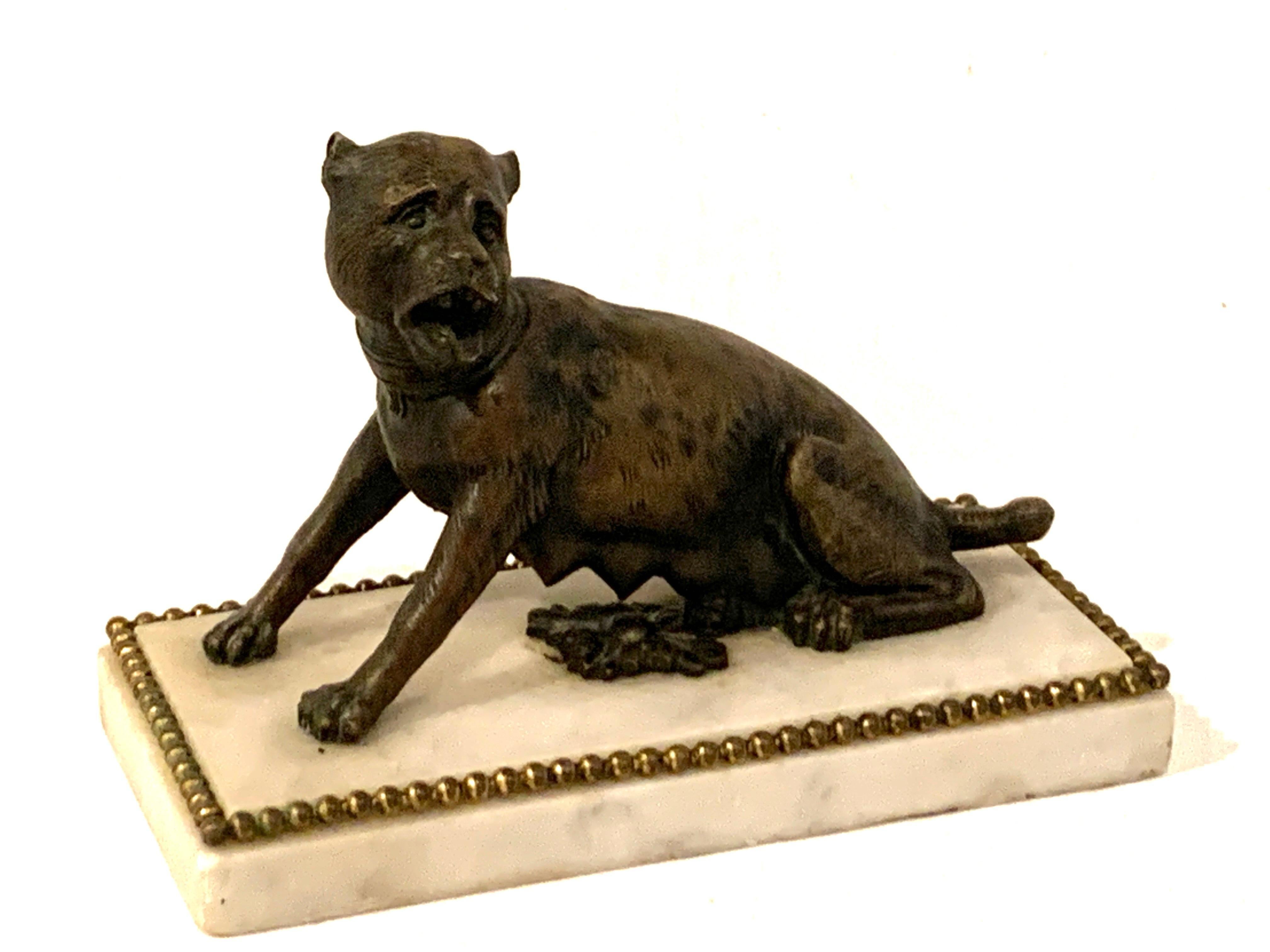 18th-19th century Italian bronze sculpture of a seated she-Wolf, similar to the Capitoline Wolf /Lupa Capitolina without, Romulus and Remus, with two front paws raised, mounted on ormolu and Carrara marble base.