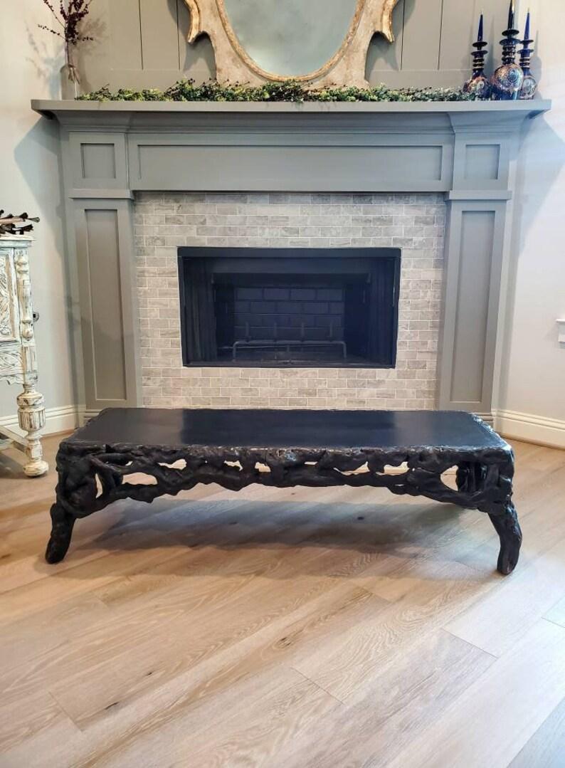 A rare Chinese ebonized rootwood table, Qing Dynasty, dating to the second half of the 18th century to early 19th century. The impressive black lacquered low table having long, inset rectangular top, sculptural natural root formation creates