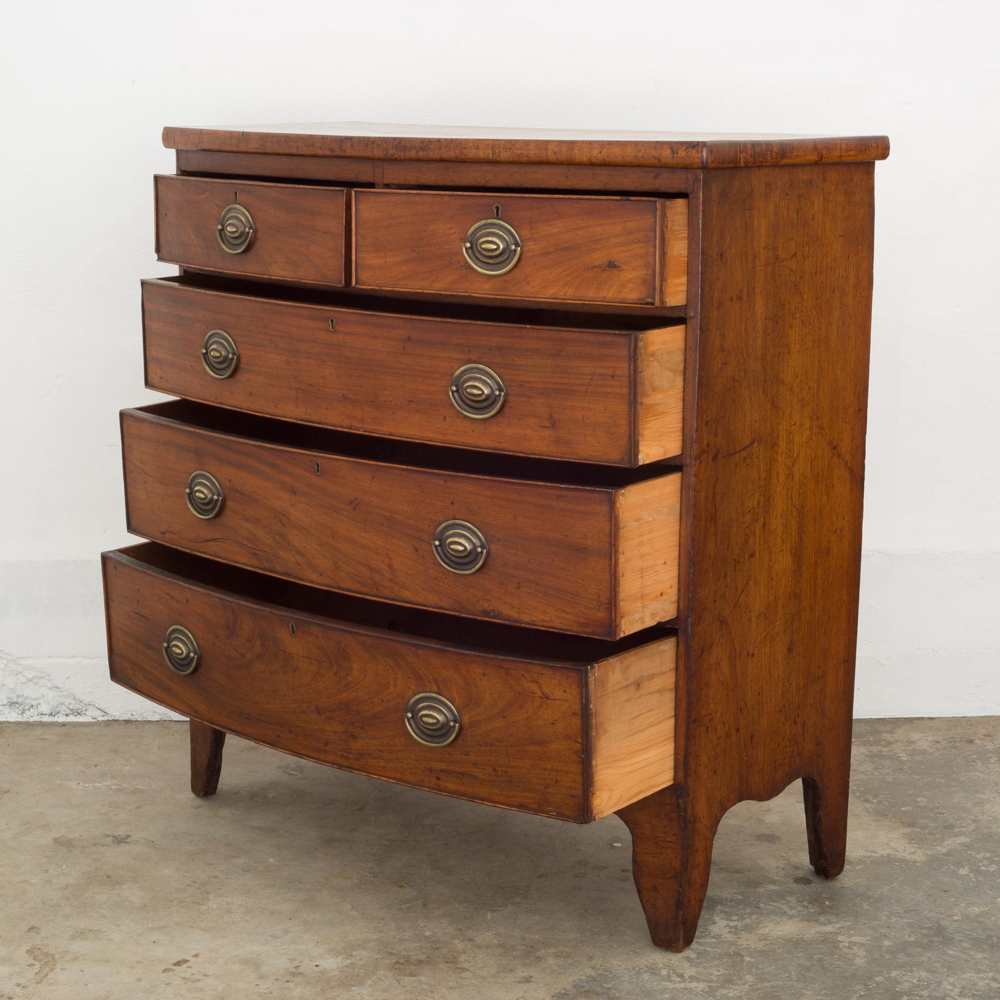 About
An antique bow front chest with original brass pulls and key holes. (No keys available.) The chest features French bracket feet and dovetails joints on all the drawers.

Creator: Unknown.
Date of manufacture: circa 1780-1790.
Materials