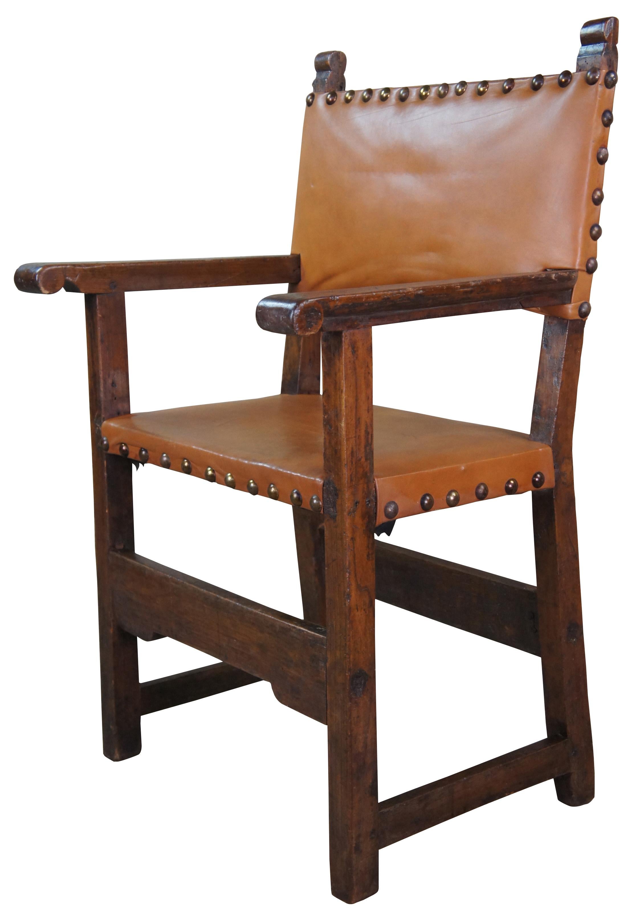 Early 18th century antique Spanish Colonial armchair with tongue and groove construction. Made of oak featuring classic form with simple ornamentation, and leather upholstery with nailhead trim. Sold by Newel Art Gallery of New York City,