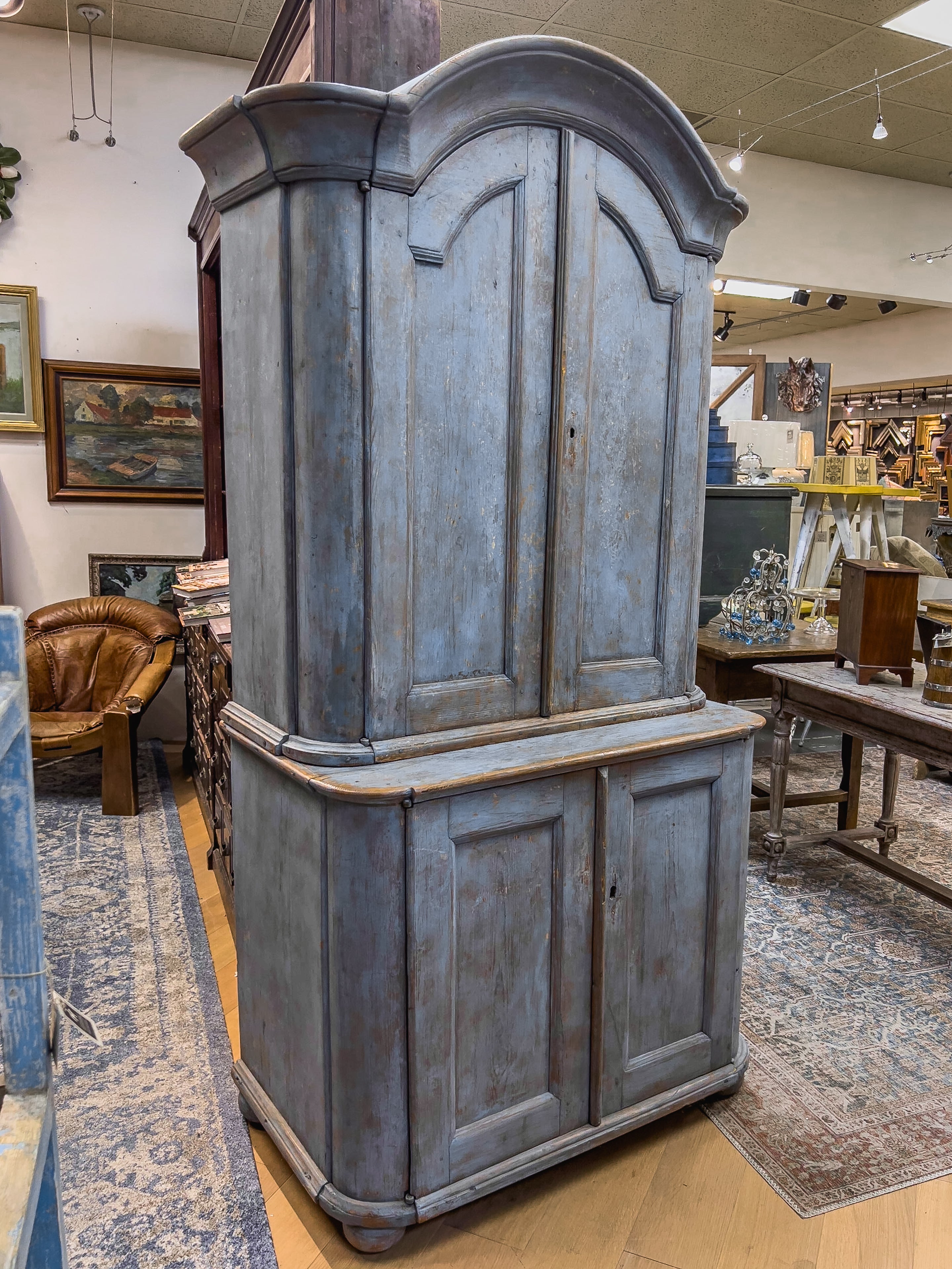 18th c. Blue Swedish cupboard. This charming cabinet comprises of two sections, the top being slimmer than the bottom. The top section offers two doors with shelves, wine glass rack and two drawers inside. The bottom section has the same. (Minus the